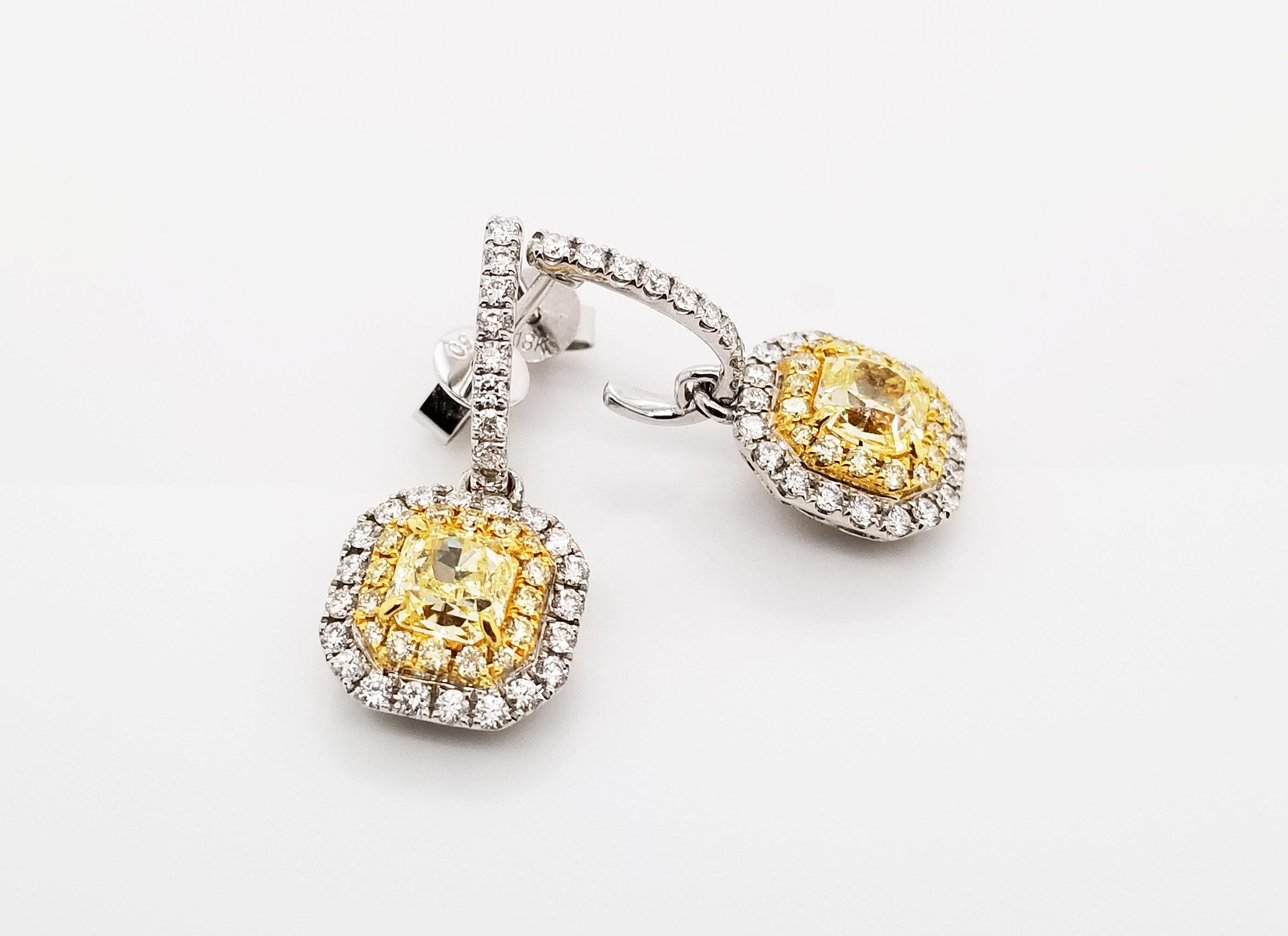 From the Couture Collection at Scarselli, these Fancy Yellow Radiant Cut Diamonds are 0.61 carats each SI2-SI1 clarity. The Yellow Diamonds are simpleness beautiful set up in an 18 karat yellow gold flanked by 0.24carats of yellow diamonds squared