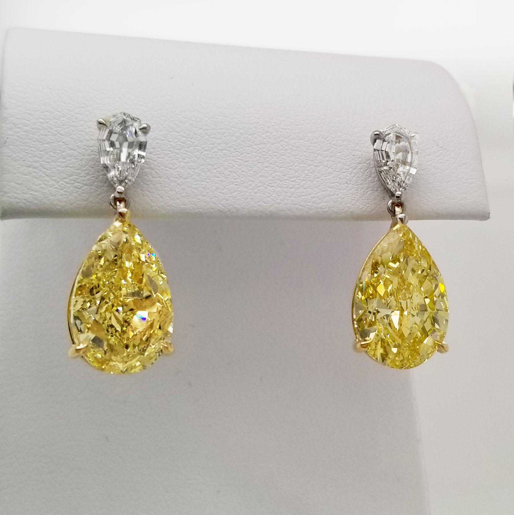 From the exclusive Collection at Scarselli, featuring matching pair 7 carats each fancy intense yellow pear shaped Diamonds VS clarity with GIA certifications (see certificate pictures for detailed stones information). The Yellow Diamonds are