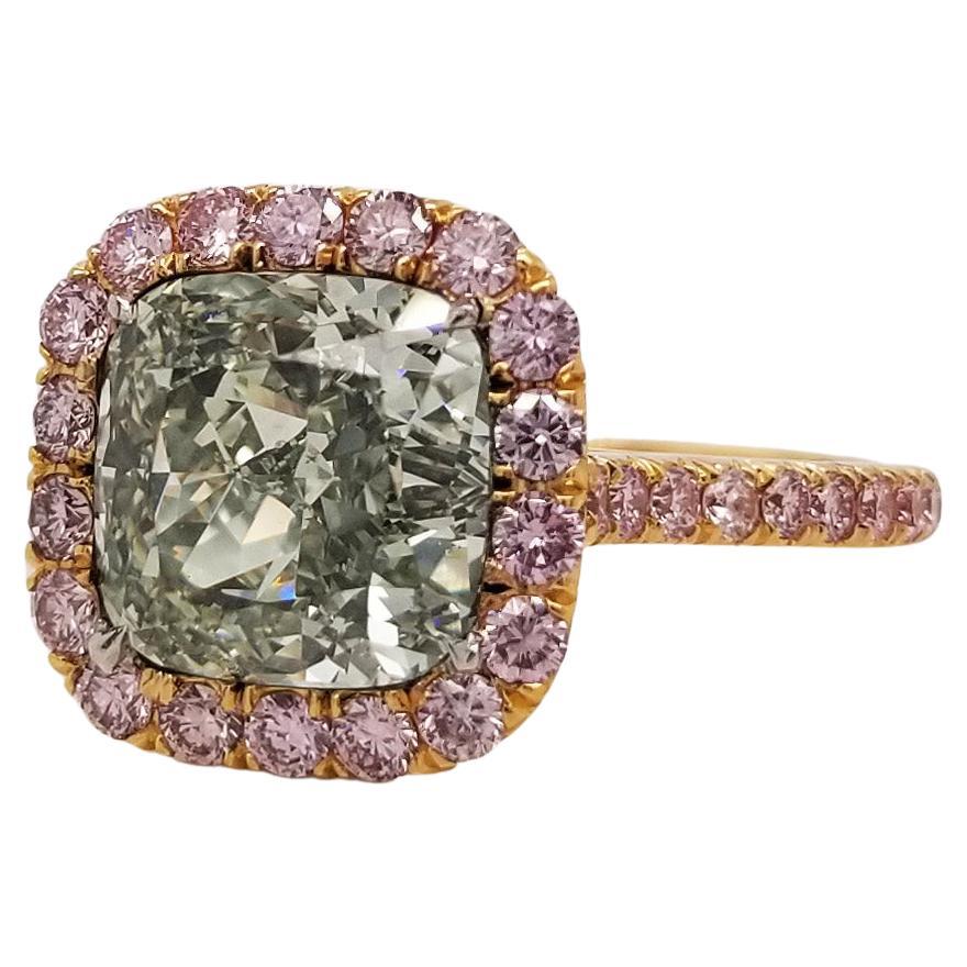 From SCARSELLI, a simply important ring featuring a 3 + carat Fancy Yellowish-Green Cushion cut diamond surrounded by 1.31 carats of pink diamonds in a coordinating handmade mounting of 18k gold (see certificate picture for detail stone