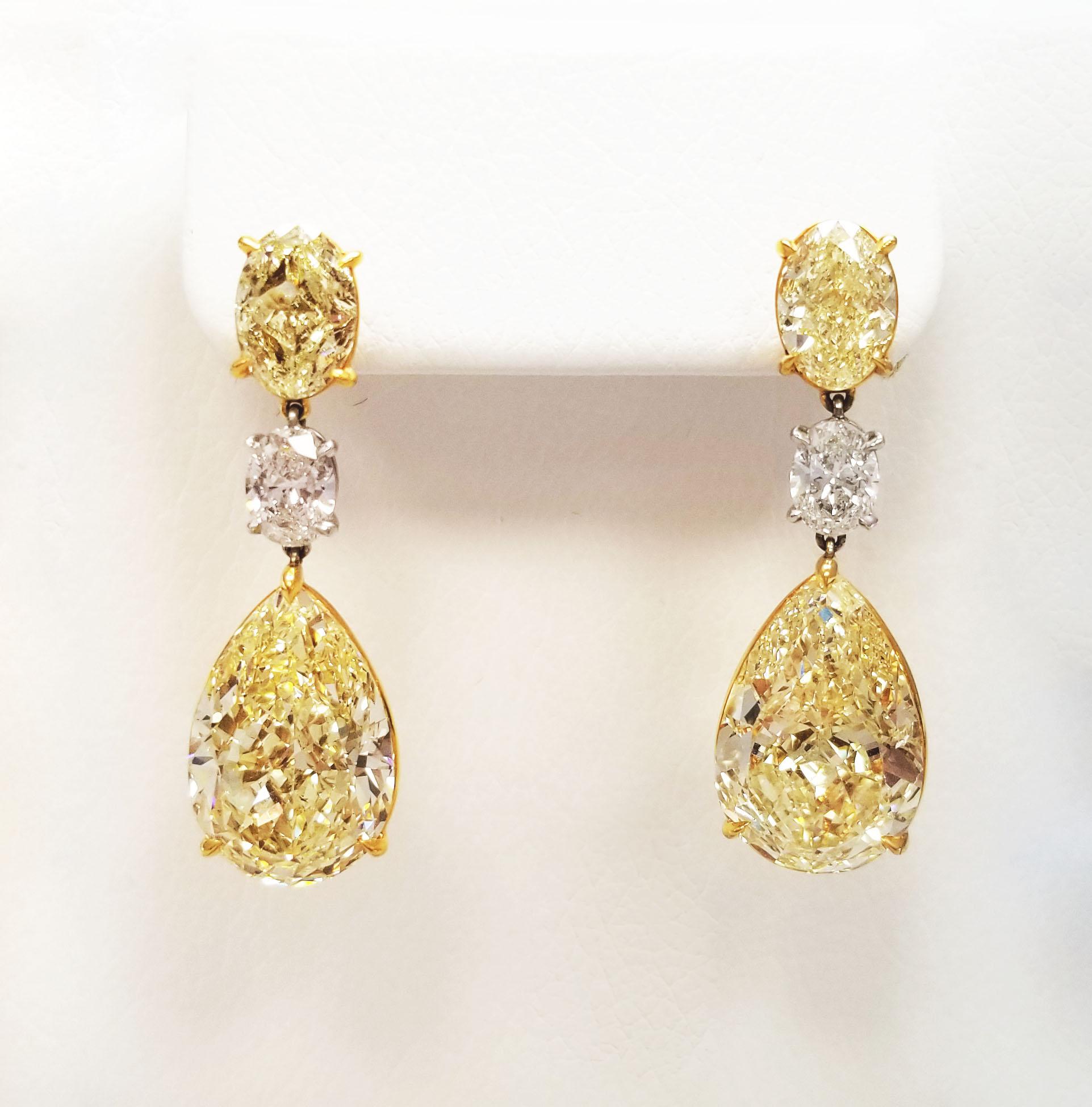 From SCARSELLI, world-renowned for investment grade natural fancy color diamonds, comes this 3 stones dangled earrings GIA certified: 2 matched pair Fancy Yellow pear shape of 8+ carat each, beautifully cut for dazzling brilliance, hanging from a