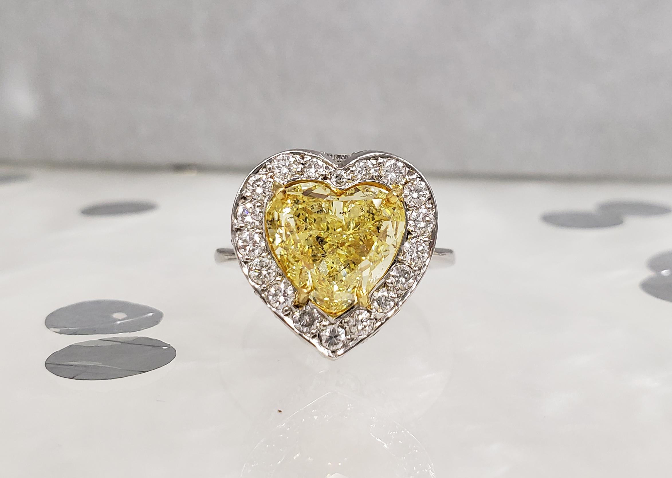 From Scarselli this GIA certified 5 carat Fancy Intense Yellow Heart Shape Diamond is I1 clarity, mounted in Platinum with 39 white diamonds totaling 3.12 carats (see certificate for detailed stone information). 

This is an exceptionally well-cut