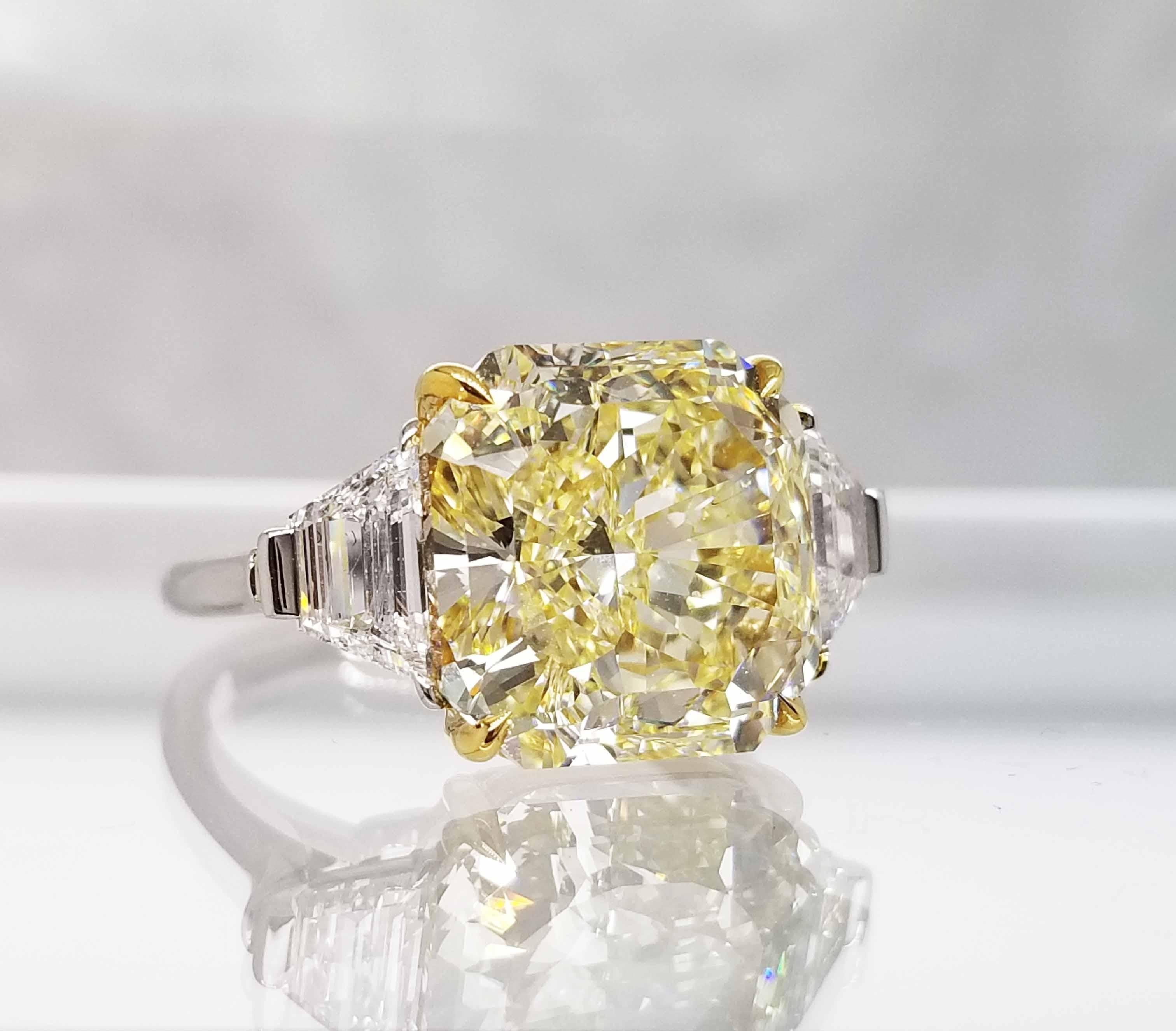 From the Collection of Scarselli this gorgeous 8.12 carat Natural Fancy Yellow Radiant cut Diamond is Internally Flawless and is classically set in  a Platinum and 18 karat yellow gold ring with .80ctw Trapezoid shape side diamonds for a clean and