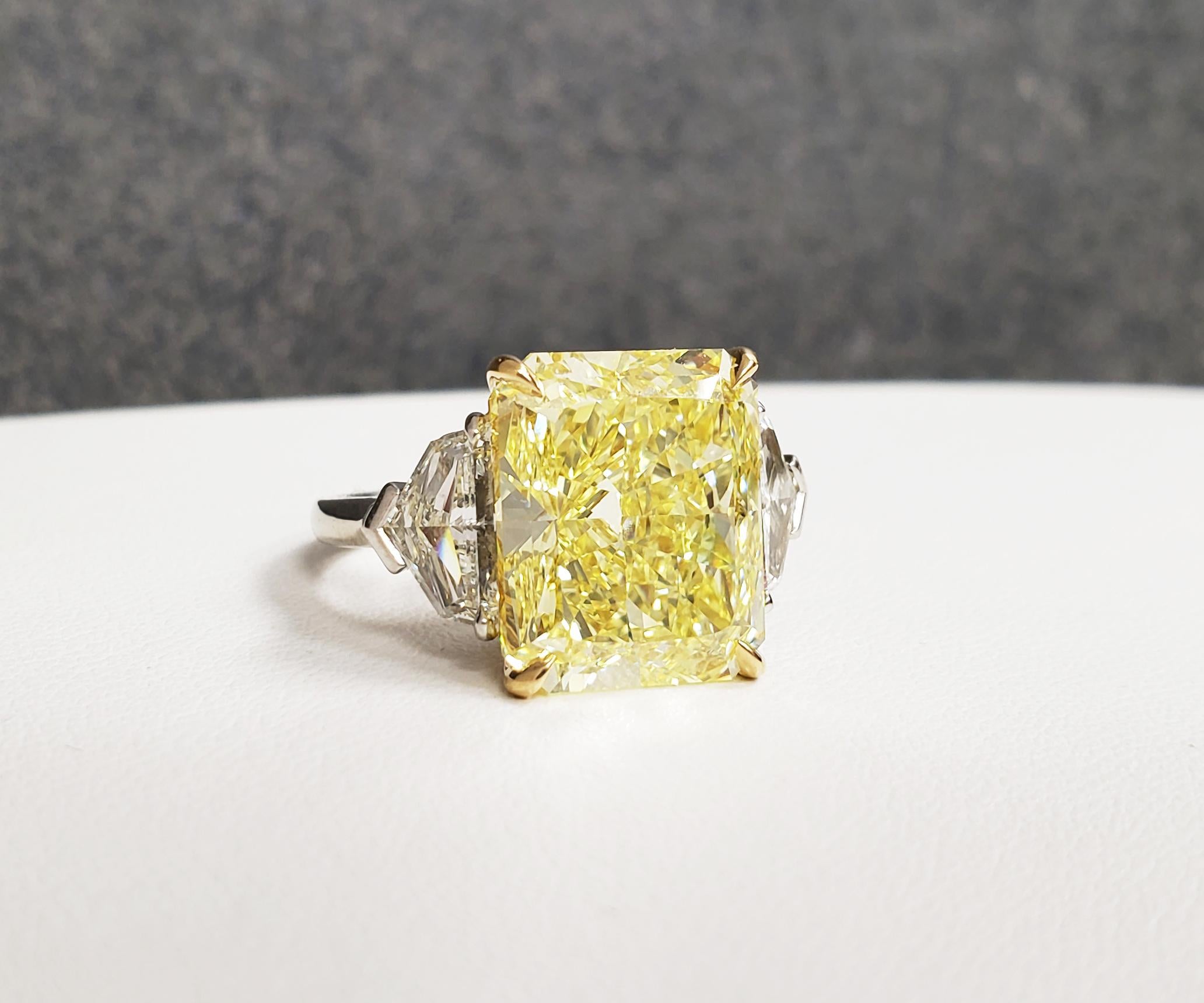 From SCARSELLI this Natural Fancy Intense Yellow  Radiant diamond of 10.02 carats, VVS1 clarity certified by GIA set with a pair of white side diamonds, cadillac cut, total weight 1.25 in a Platinum and 18k yellow gold ring. Inquiries are