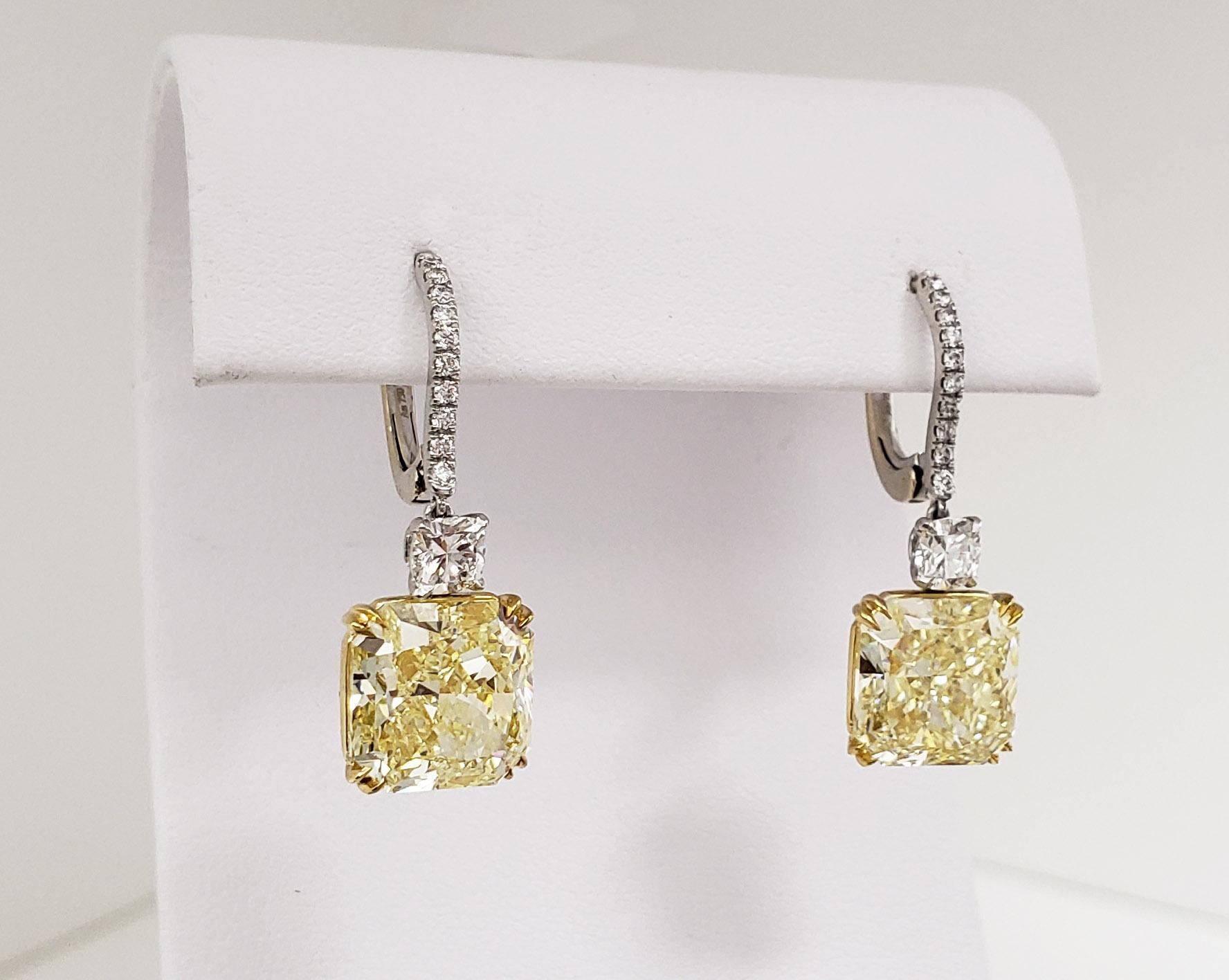 From SCARSELLI, this matched pair of Fancy Yellow diamonds, beautifully cut for dazzling brilliance. The yellow radiant cut diamonds 5 carats each VS2 clarity (see certificates pictures for more detailed stones' information) hang from a classic