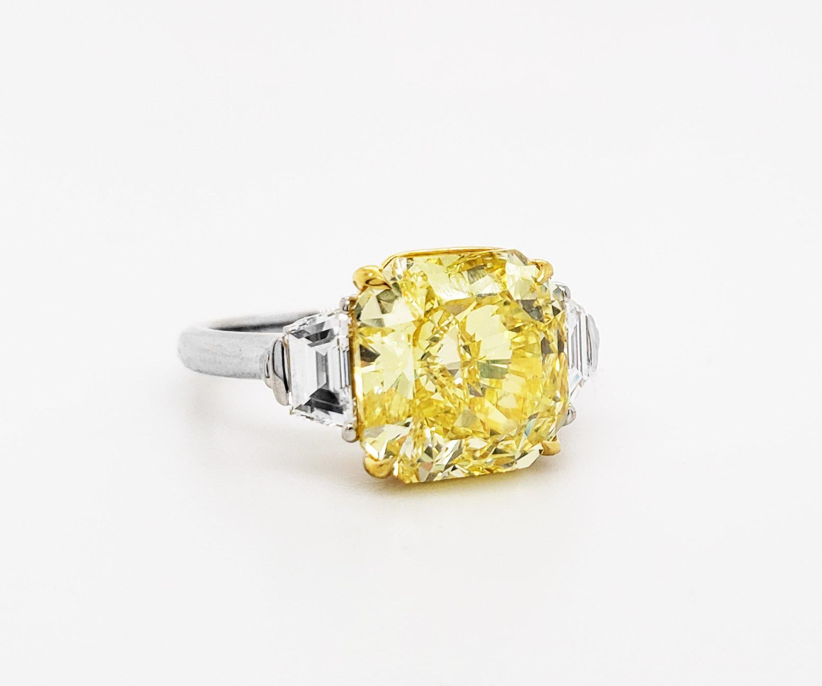 From SCARSELLI, this beautiful statement ring features a 5.00 carat Fancy Vivid Yellow Radiant Cut Diamond of VVS2 clarity flanked with trapezoid cut white diamonds 0.70carat (.35 each) See pictures for details. (see certificate picture for more