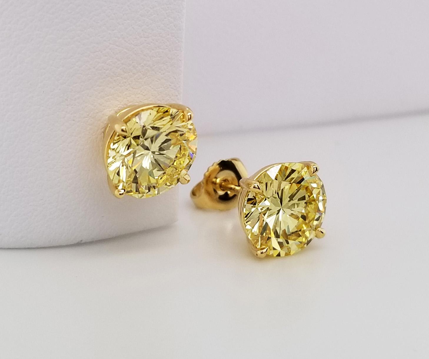 Matching pair of 3-carat, natural fancy intense yellow round diamond stud earrings on 18k yellow gold. GIA-certified stud earrings with VS1 and VVS2 fancy intense yellow diamonds from Scarselli.

A new classic to add to your jewelry capsule