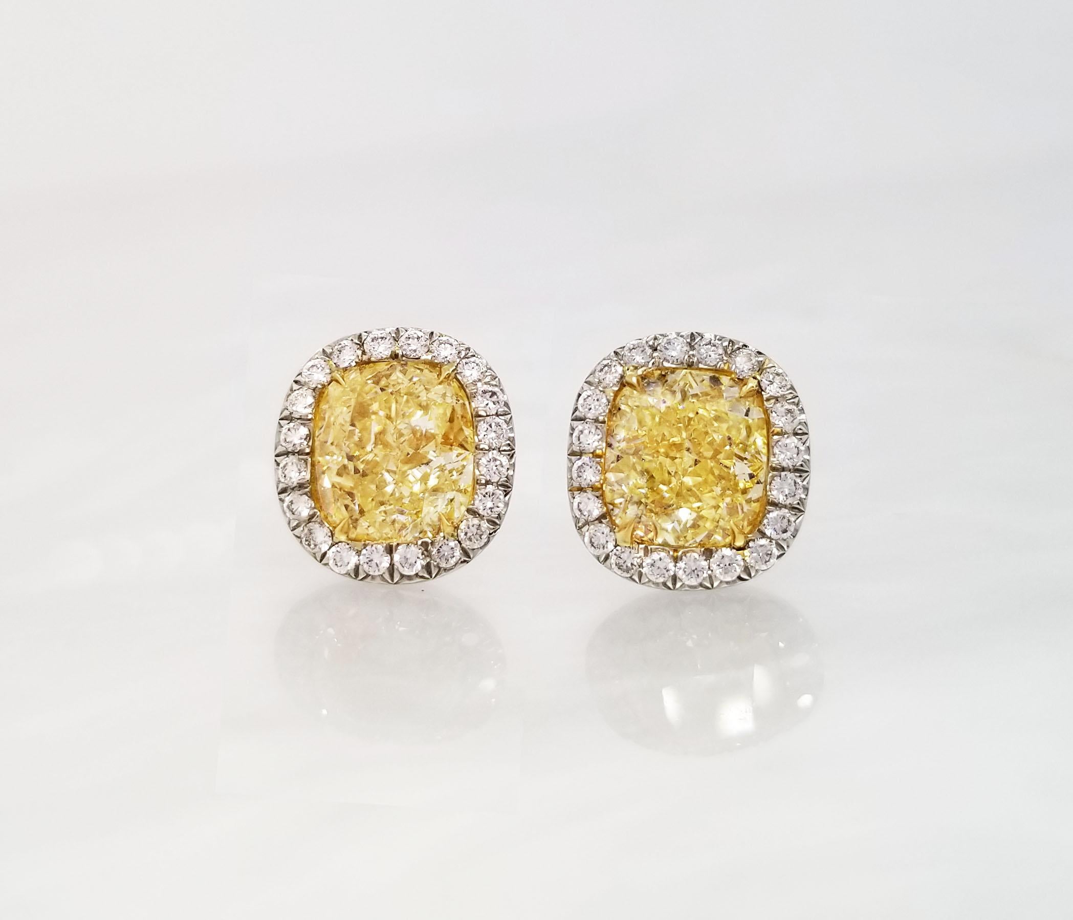 From Scarselli collection these Fancy Yellow Diamonds center stones 2 carats, cushion cut, and clarity certified by GIA (see certificates pictures for detail stone's information) The Yellow Diamonds are simpleness beautiful set up in a Platinum