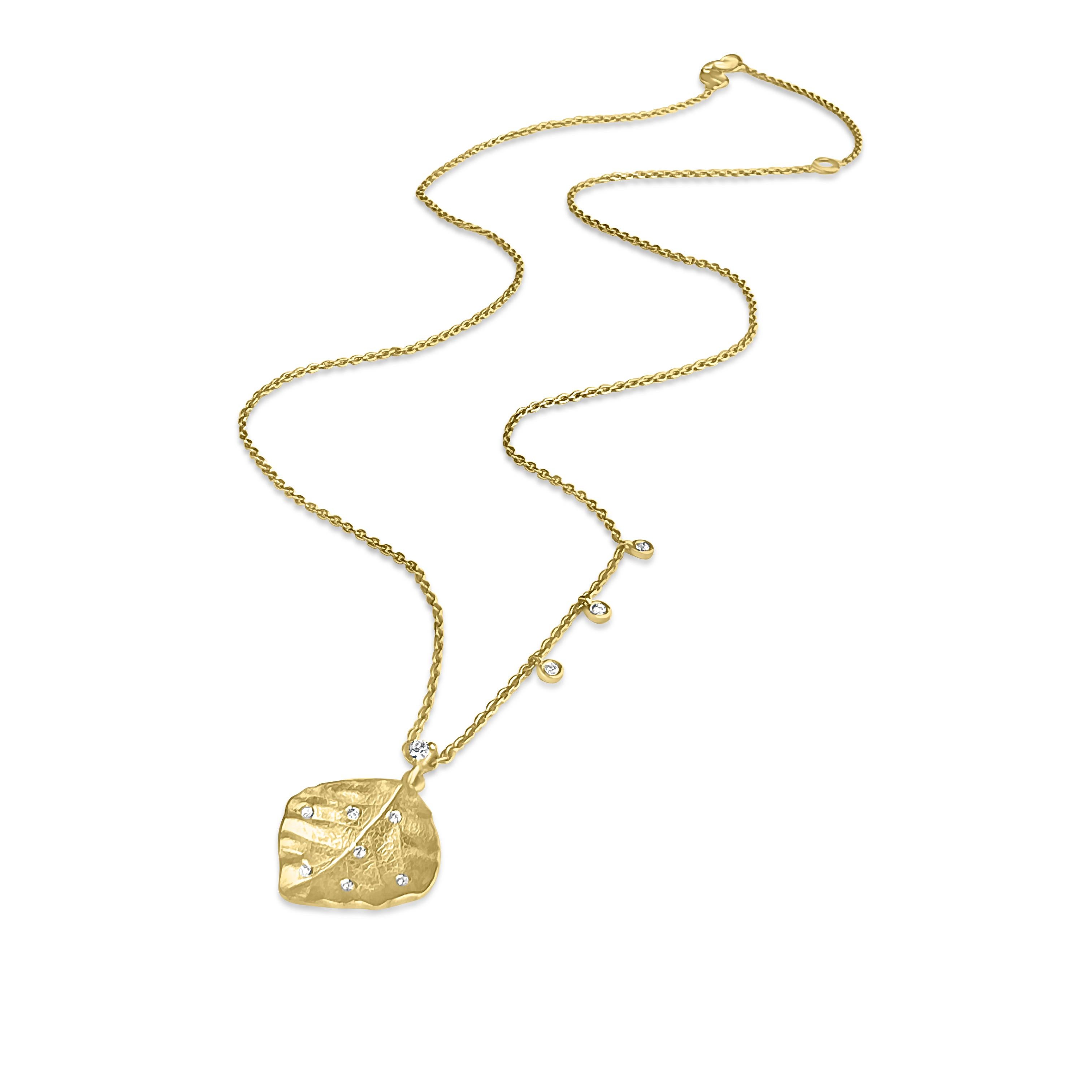 Isabel Alexander takes the subtlety of solid gold and the sparkle of the classic diamond and infuses them into a beautiful, elegant and modern shape. Unique textures are creatively mixed with scattered diamonds in this one-of-kind leaf necklace.