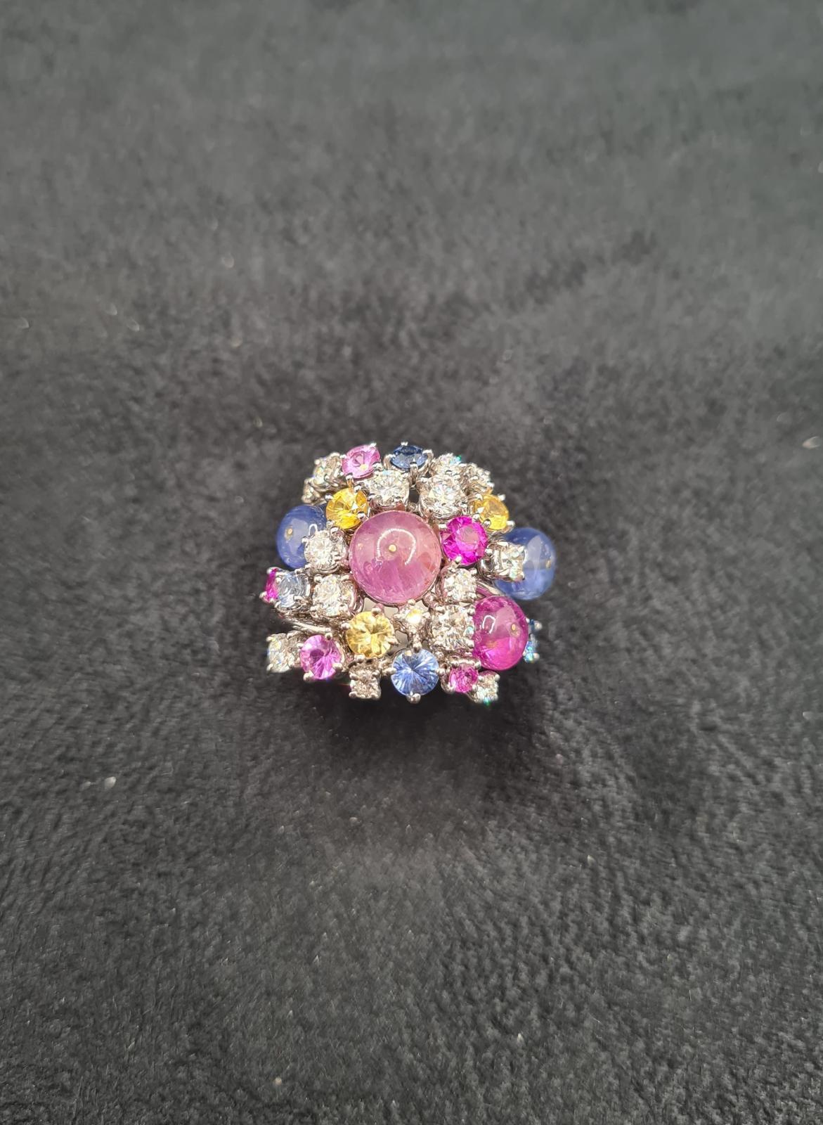 Introducing the captivating MOUSSE POLYCHROME SAPPHIRES RING, a mesmerizing symphony of colors and sparkle. Crafted with white gold, this ring features a harmonious blend of round brilliant cut diamonds and polychrome sapphires, adorned with vibrant