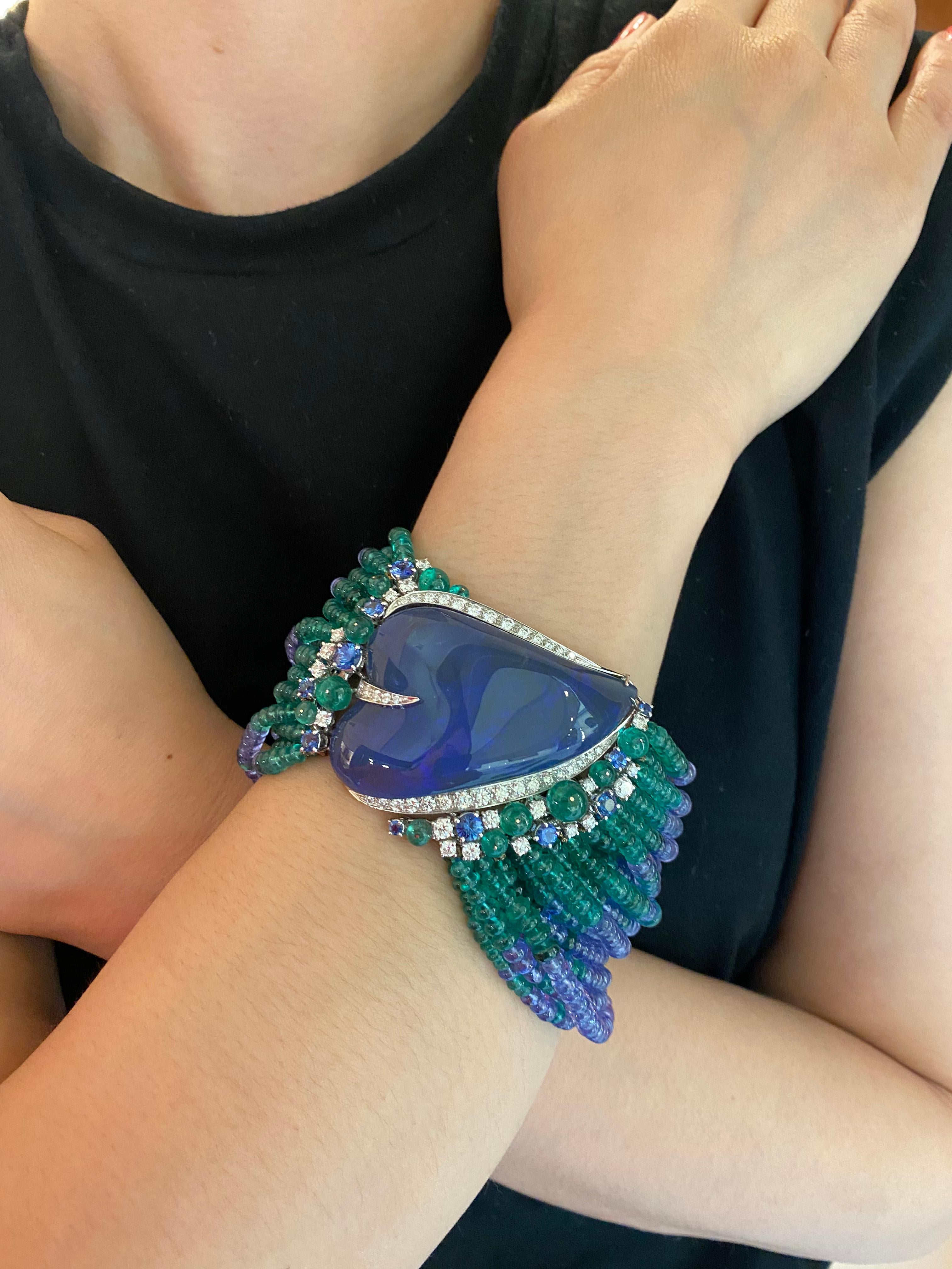 Introducing the majestic POSEIDON TANZANITE AND EMERALD BRACELET, a testament to opulence and sophistication. Crafted with white gold, this bracelet features a dazzling array of diamonds pave, tanzanite and emerald beads threads, and rounded