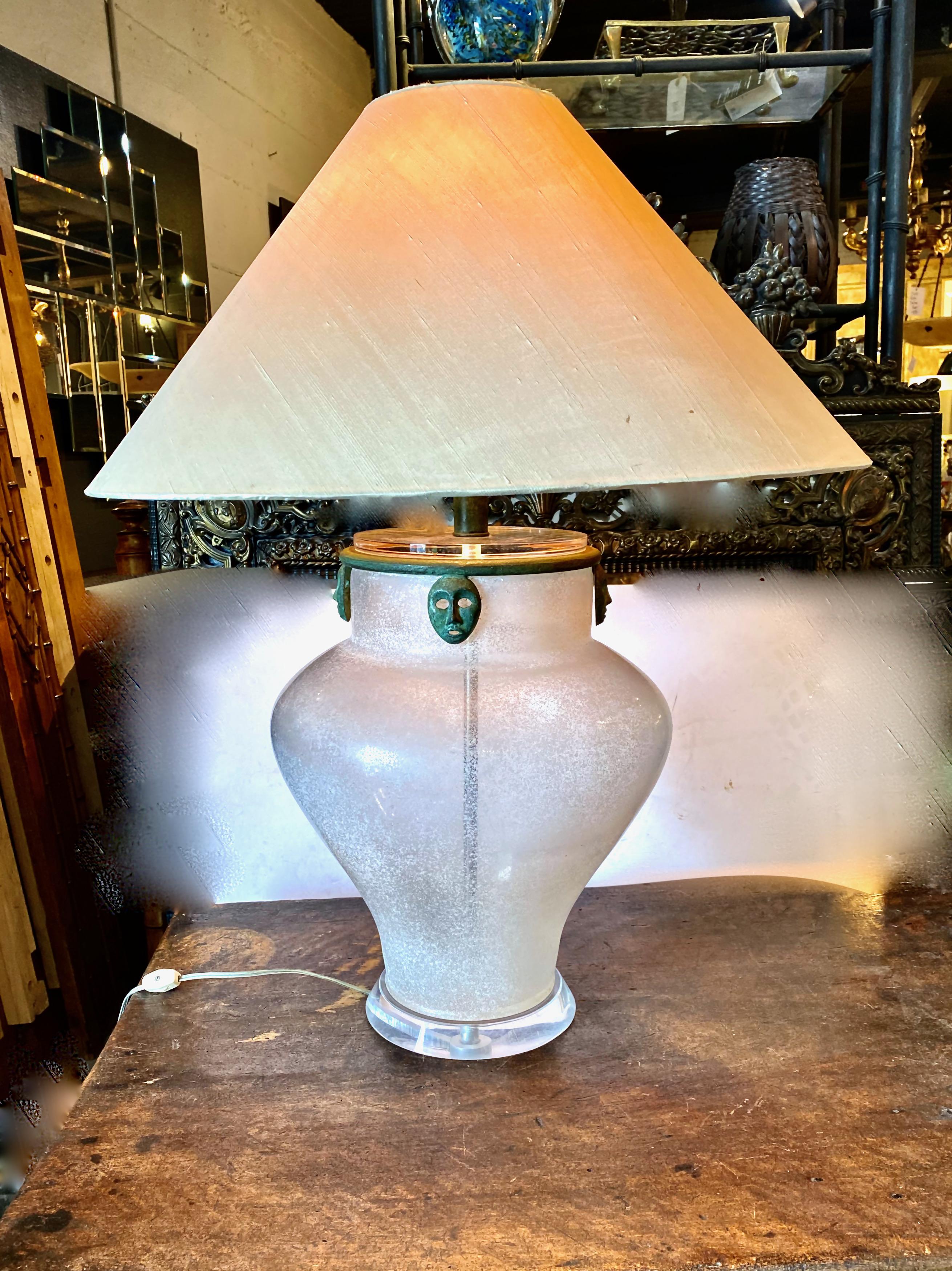 Voici un magnifique exemple de vase Scavo Corroso* de la fin du 20e siècle, attribué à Seguso/Karl Springer, qui a été magnifiquement détaillé avec un collier en bronze avec des masques en bronze de style archaïque suspendus. Le vase a été percé et
