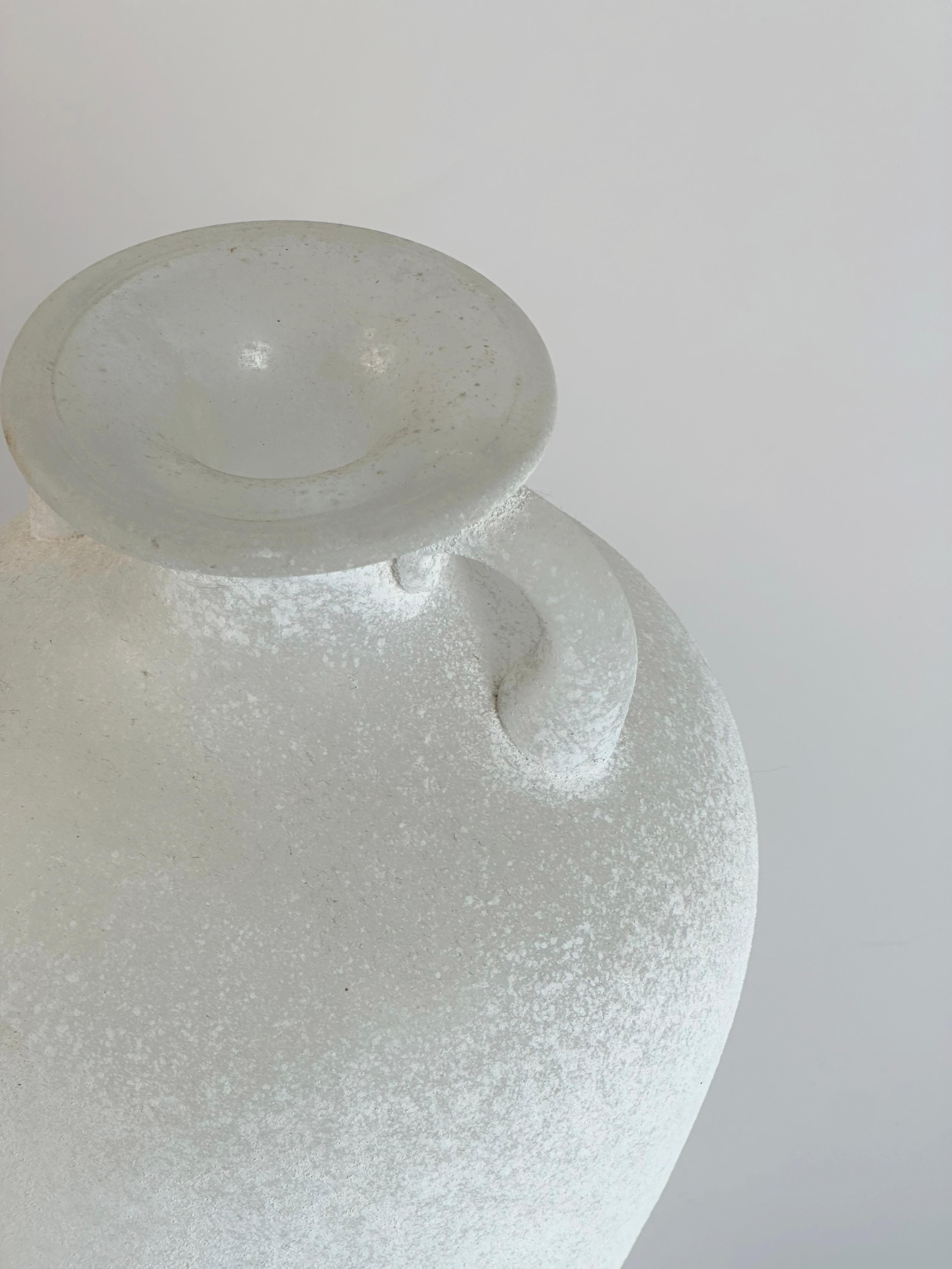 A striking white amphora-form vase by Seguso Vetri d’Arte, produced in Italy during the 1980s and attributed to their bespoke collaborations for Karl Springer. 
Handblown in Murano, the vase presents a baluster-shaped body rising from a narrow,
