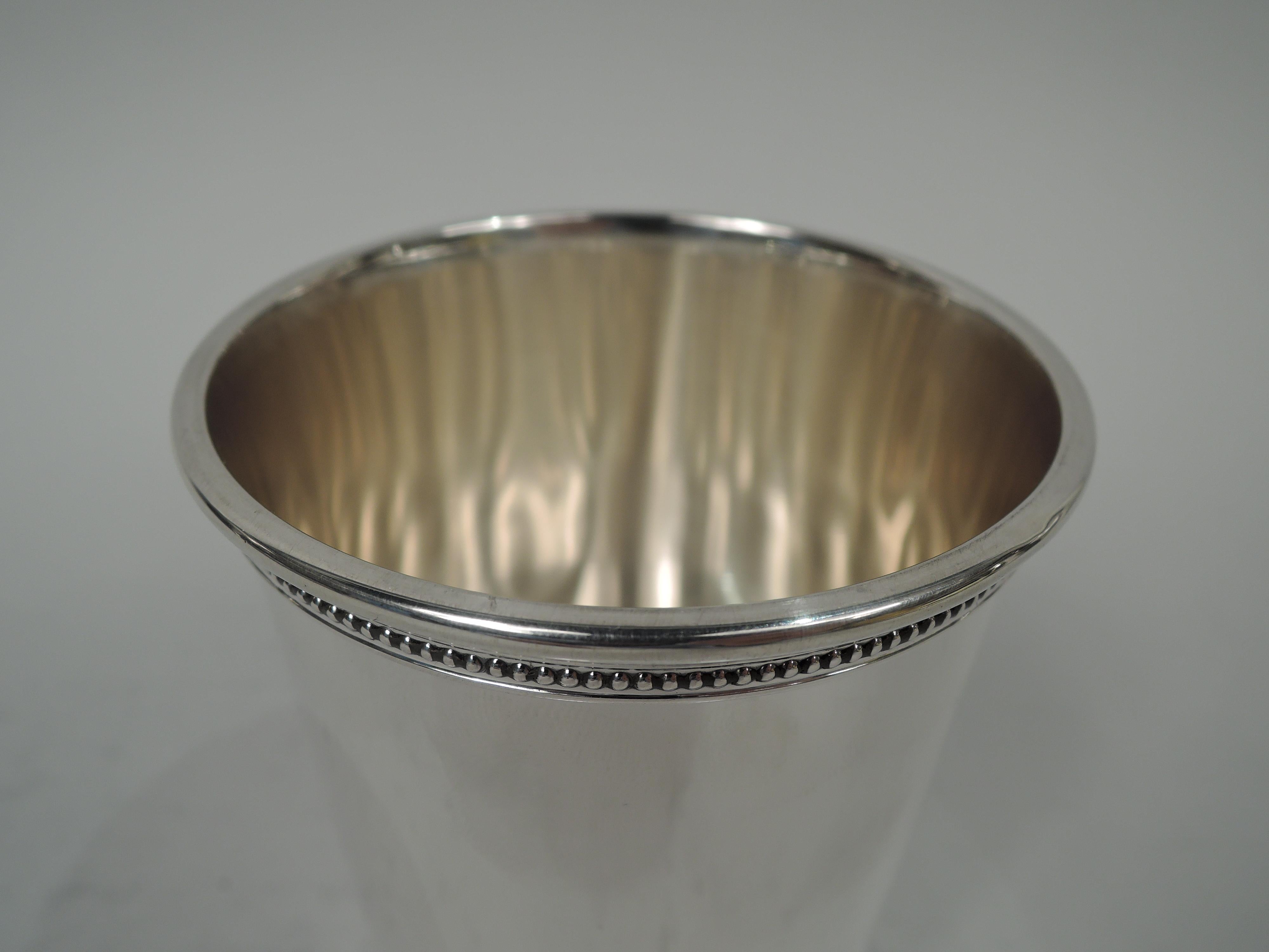 Reagan-era sterling silver mint julep cup. Made by Scearce in Shelbyville, Kentucky. Straight and tapering sides, and beaded and molded rim and foot. Ronald Reagan was president from 1981 to 1989. Marks include maker’s stamp and presidential date