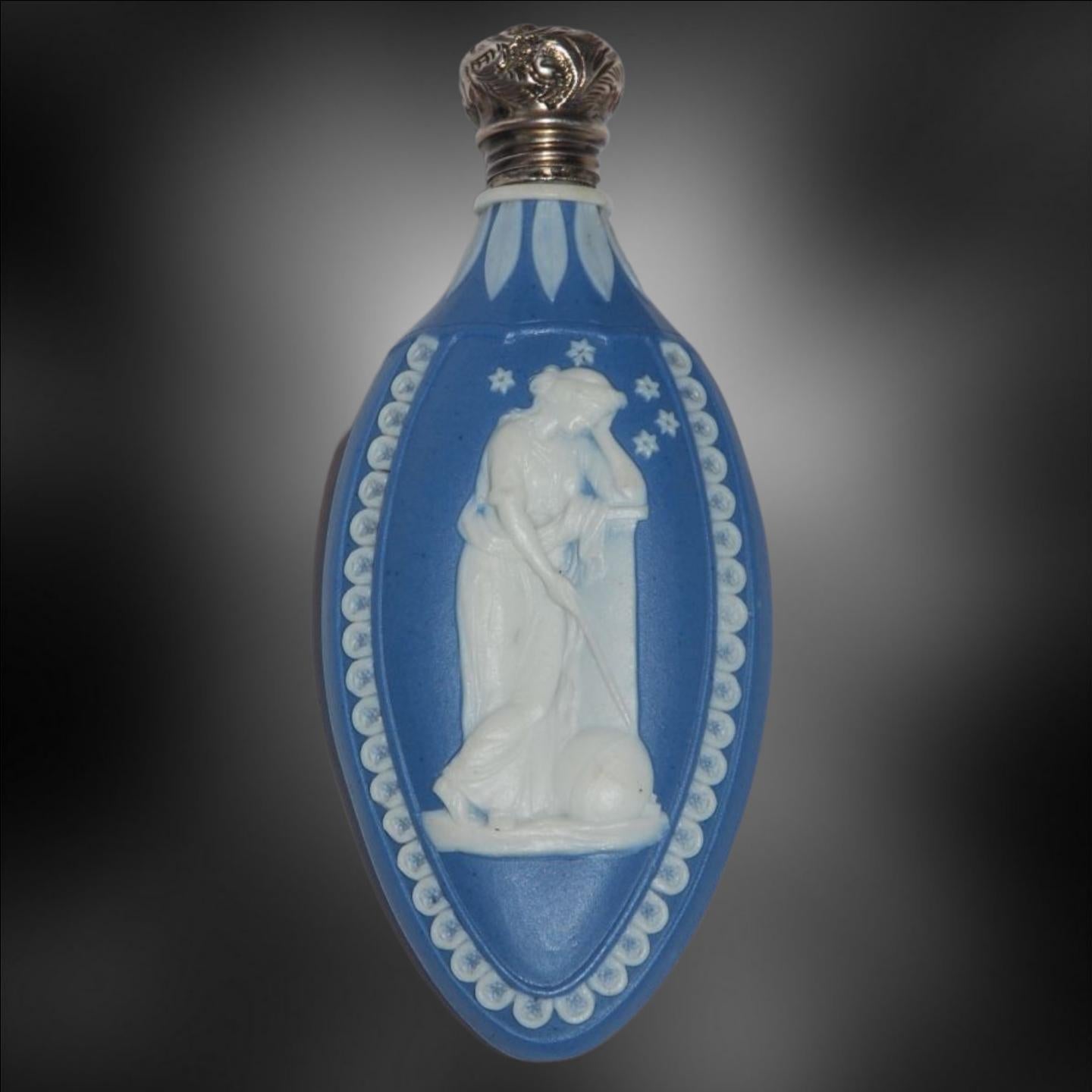 A scent bottle in cobalt blue jasperware, with original silver Cap and dipper.

In solid blue jasper, with the muses Urania and Euterpe: Astronomy and Lyric Poetry. Once the formula became known, Neale produced high quality jasperware, as in this