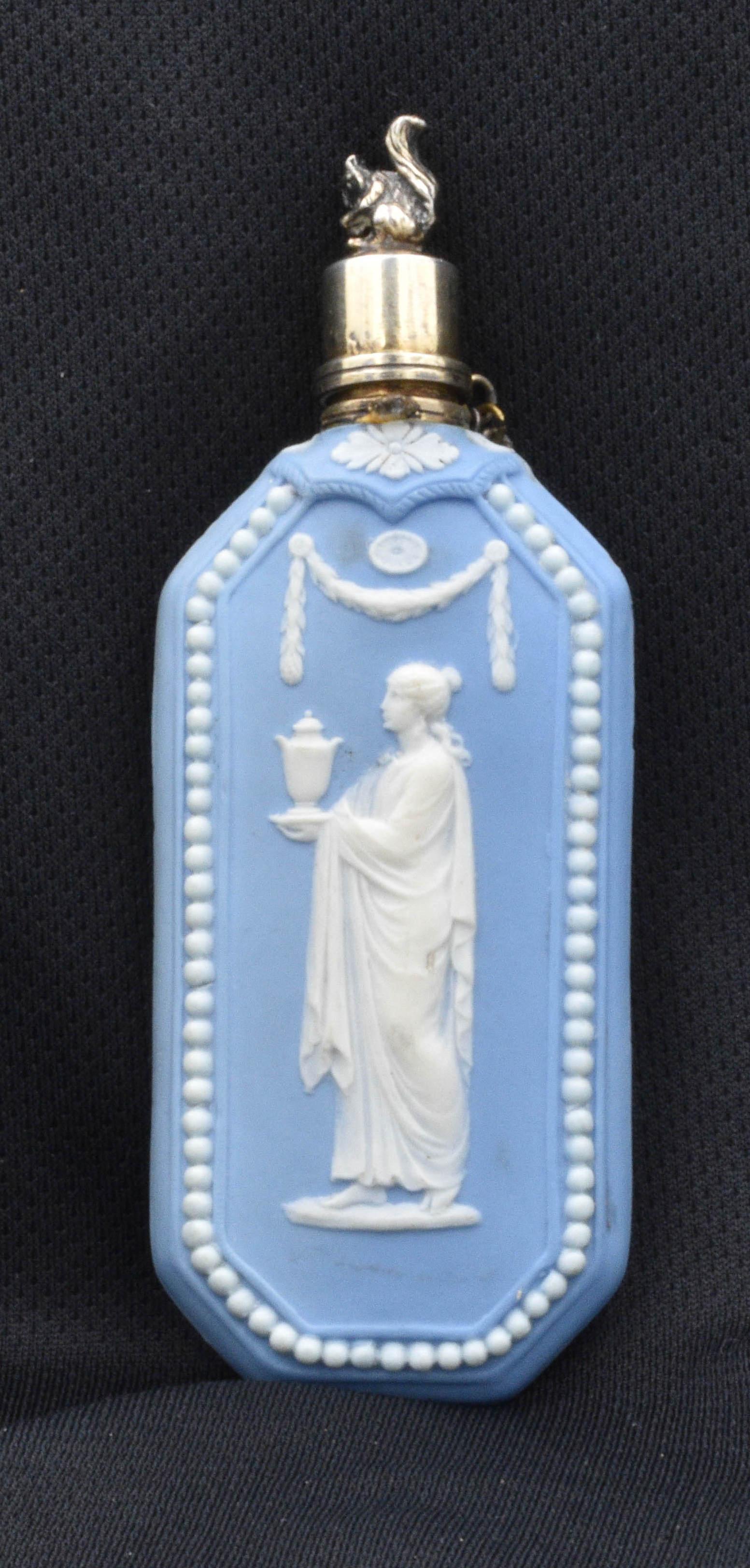 A scent bottle in pale blue jasperware, with original silver cap with chain, surmounted by a wonderfully wrought squirrel.

Note the way the beads have been added individually; this was only done in the 18th century, when labour was
