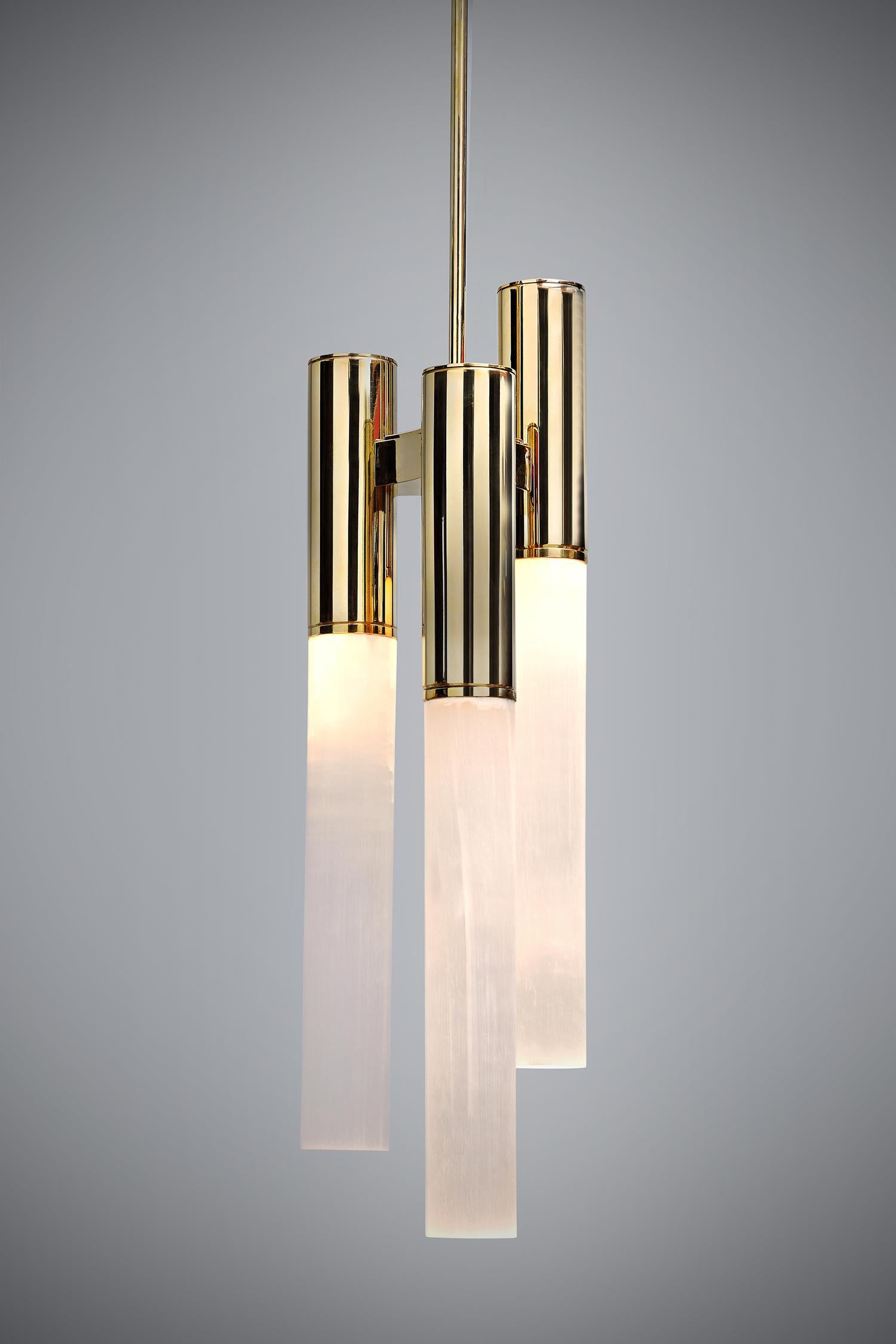 A beautiful feature for any room, our Sceptre Pendant is hand finished in polished brass and three large carefully polished rock crystal rods. Each rod is lit from the top giving an ethereal softness. Looks fabulous above a console or bedside or