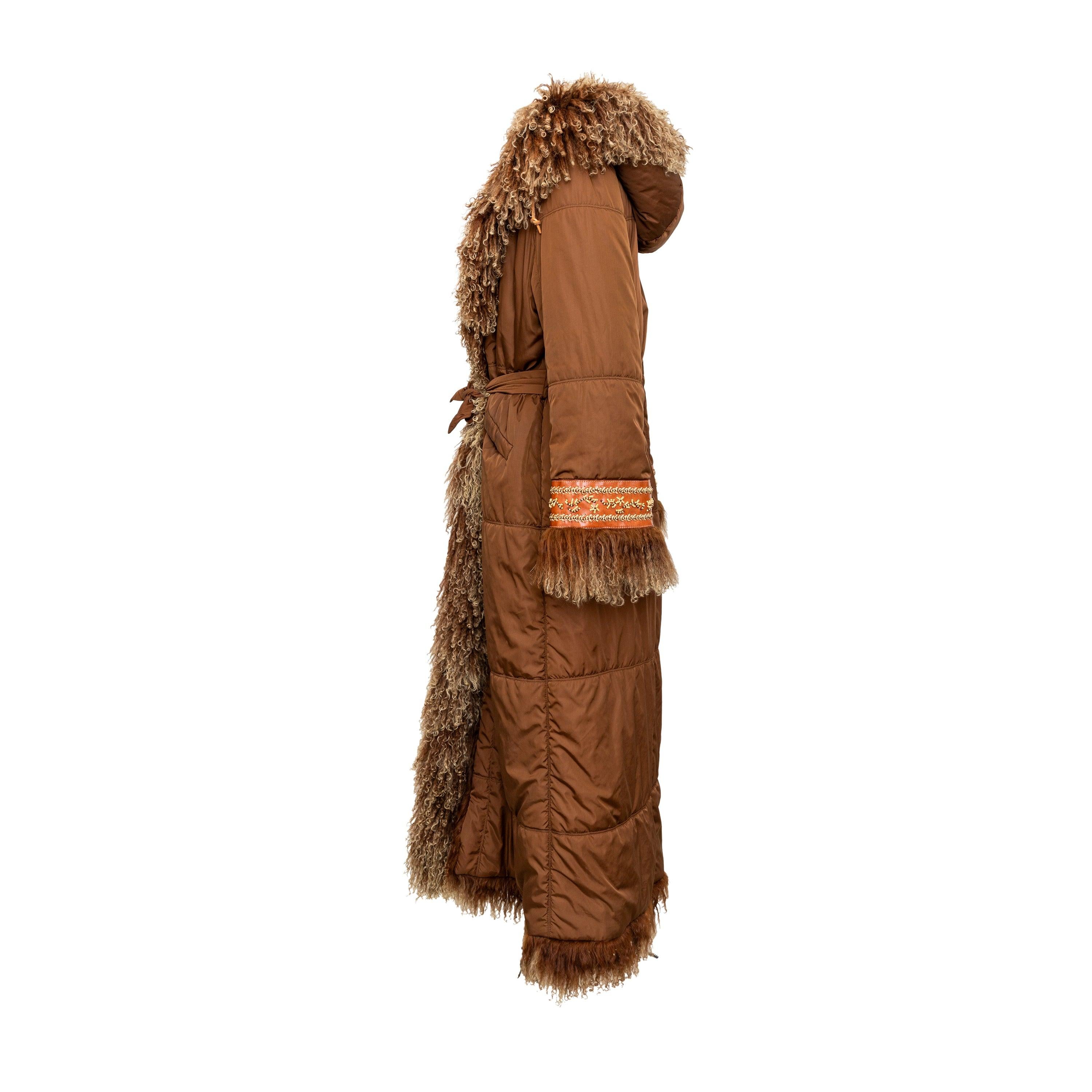 This long overcoat in brown nylon fabric is perfect for cold weather. It features a tie-knot at the waist and luxurious fur trims on the front, hood, and sleeve hem. The leather trim on the sleeve hem is embellished with intricate beadwork for added