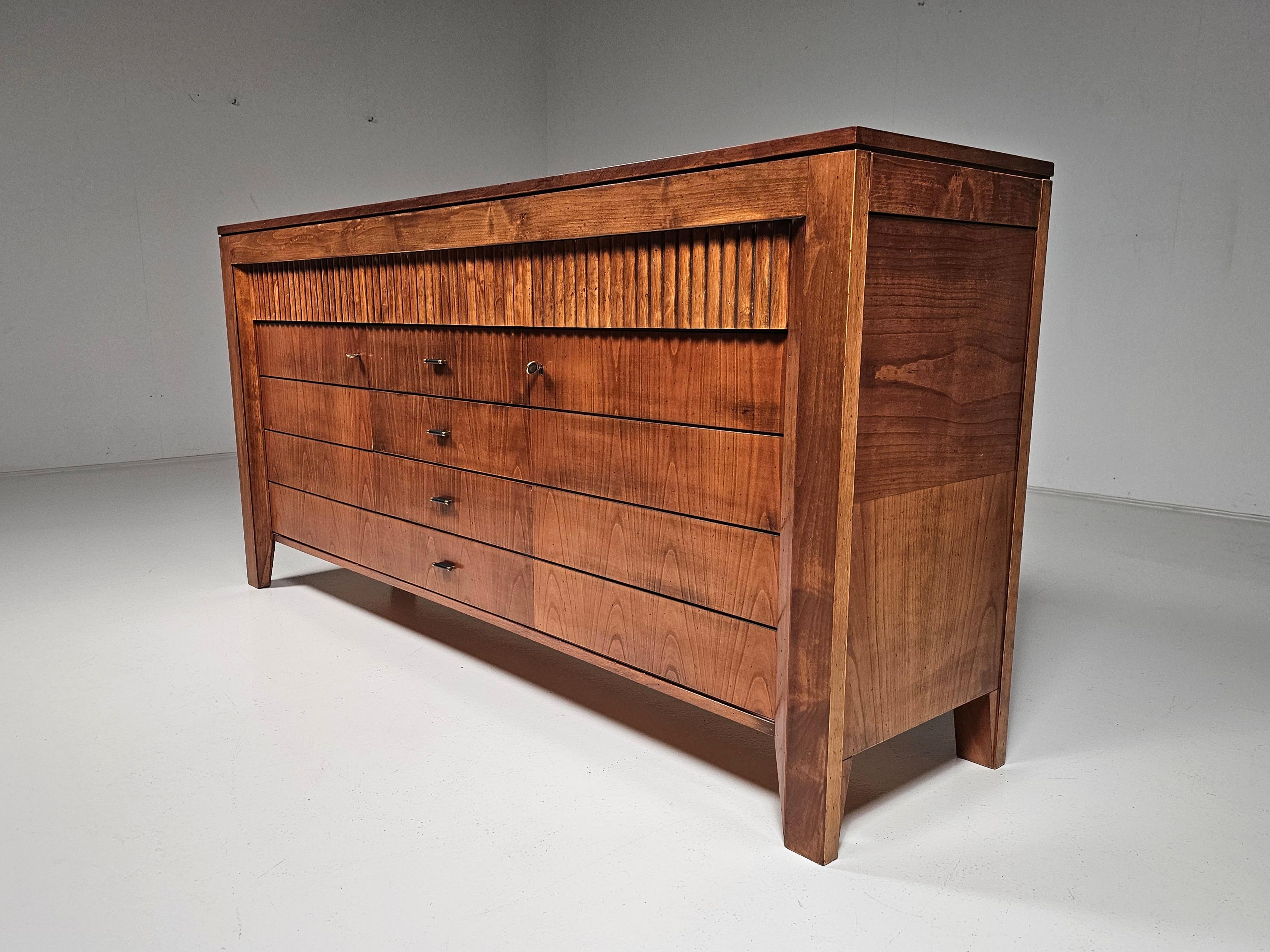 Schacchi sideboard, walnut wood, Morelato, Italy, 1970s

Sideboard made of cherry wood with fine chessboard veneer on the top and sides. 2 hinged doors, 4 central drawers, 3 drawers with precious milling, and 2 retractable side drawers. Bamboo look