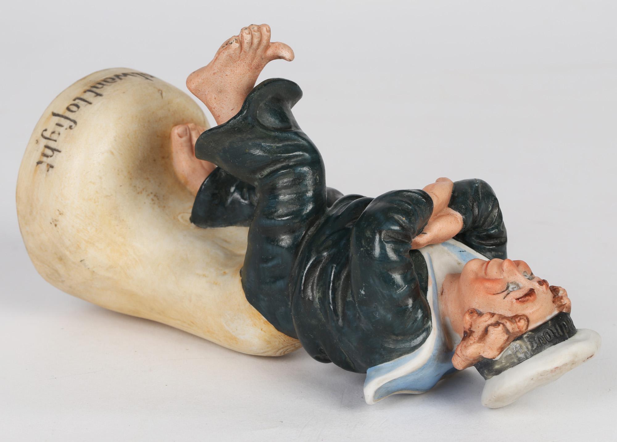 A scarce German porcelain figure of a sailor titled 'We dont want to fight' made by Schafer & Vater and dating from around 1900. This finely made novelty figure portrays a bare footed sailor in sailor costume and wearing a hat bearing the word