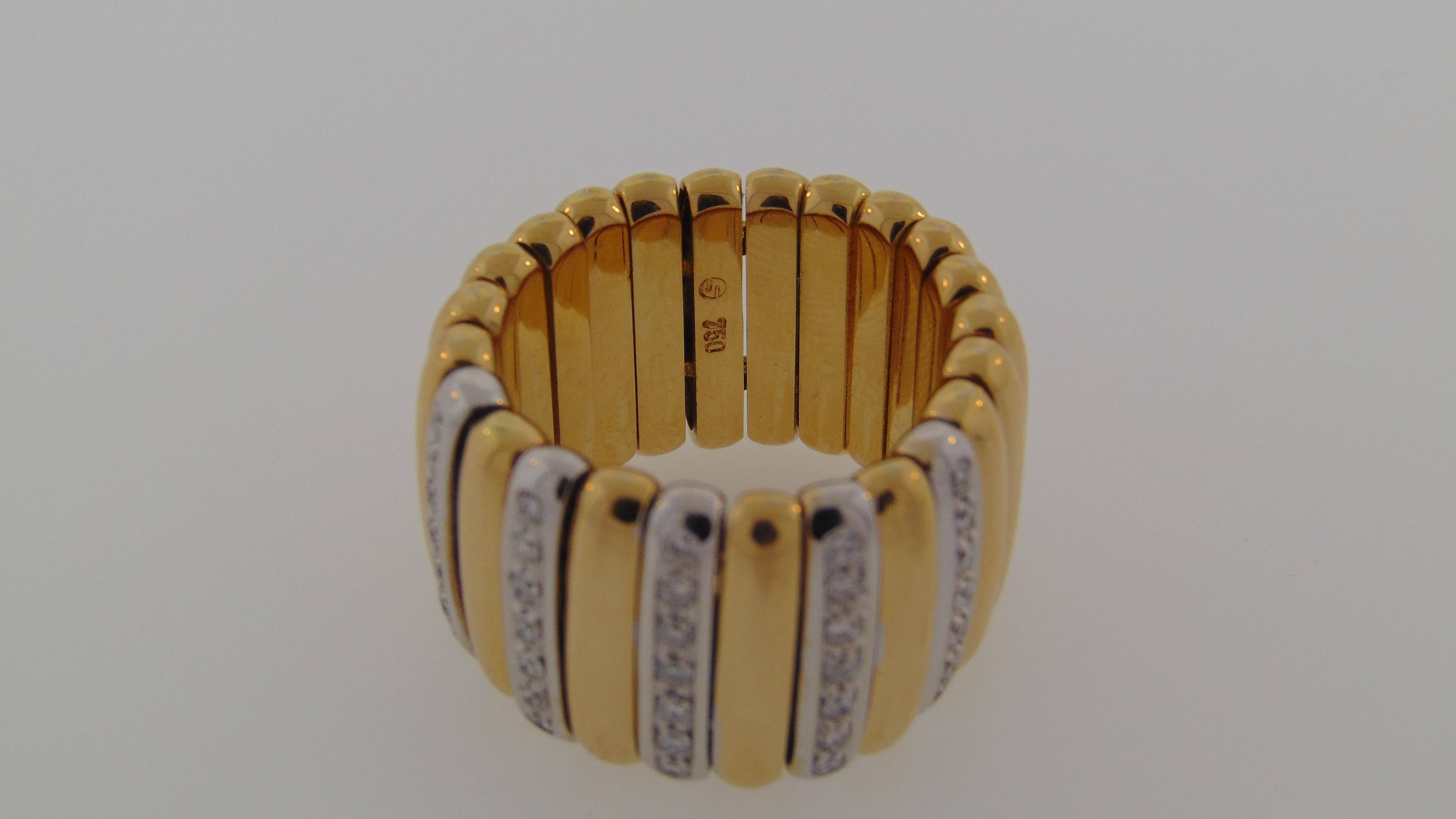 Luxuriously crafted in Germany, designed by Scheffel, Schmuck.  Smooth and easy to wear wide flexible link band, made of 18 karat yellow gold.  The ring is composed with five (5) 18 karat white gold vertically positioned bars, each set with seven