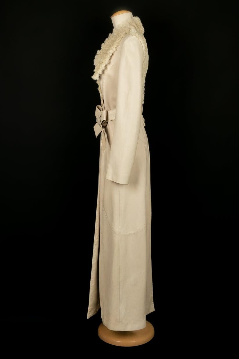 Jean-Louis Scherrer - (Made in France) Long coat in cream-colored lamb, collar and back enlivened with rabbit, and partially embroidered with cannetilles, pearls and rhinestones. 
Size indicated 38FR. 
To be noted, a small stain on the