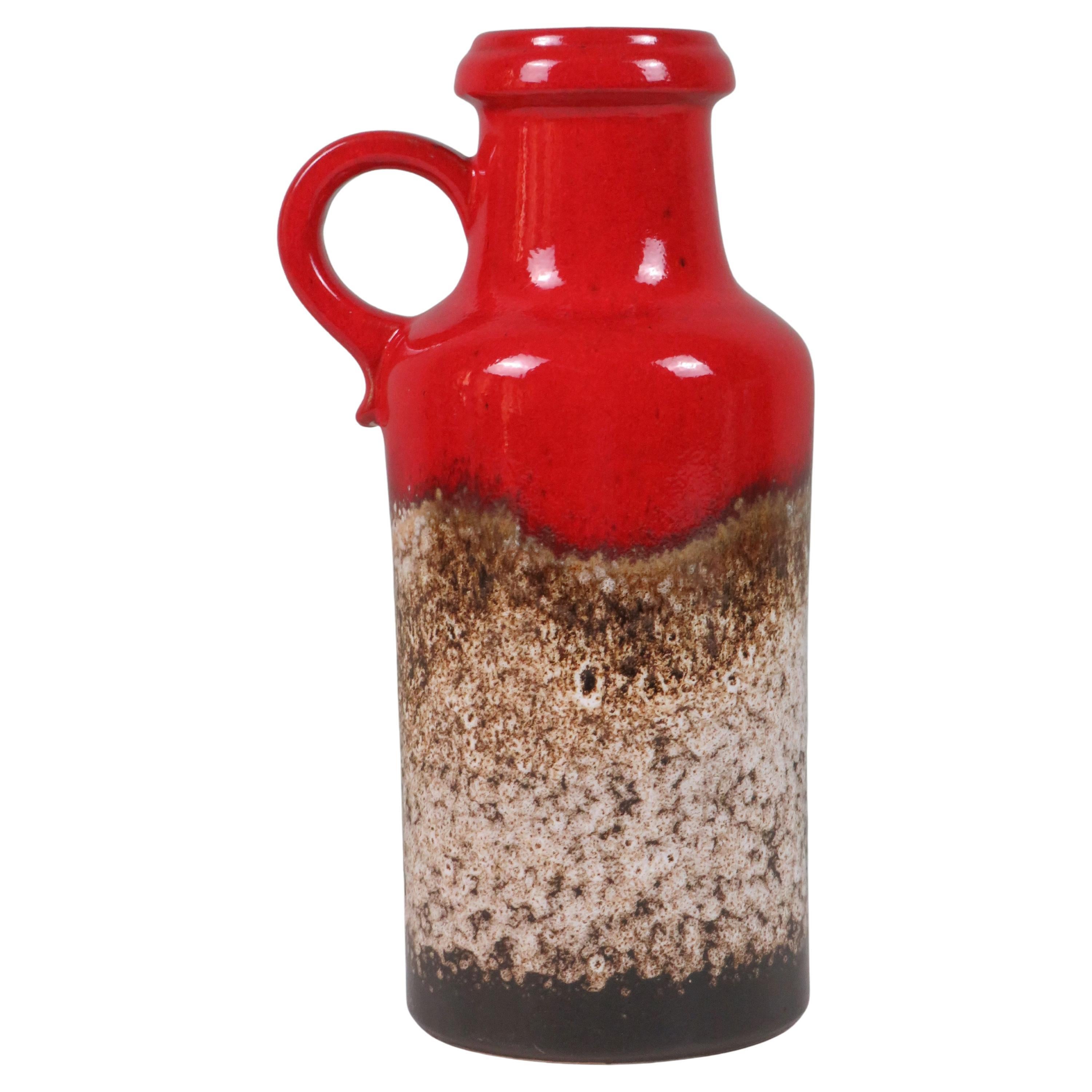A rare Scheurich Fat Lava ear vase, model 407-35, crafted in West Germany ca. 1970. Featuring vibrant red glaze and heavy textured lava drip in brown and cream, this tall piece showcases the height of postwar ceramic artistry.

Height: 35 cm 