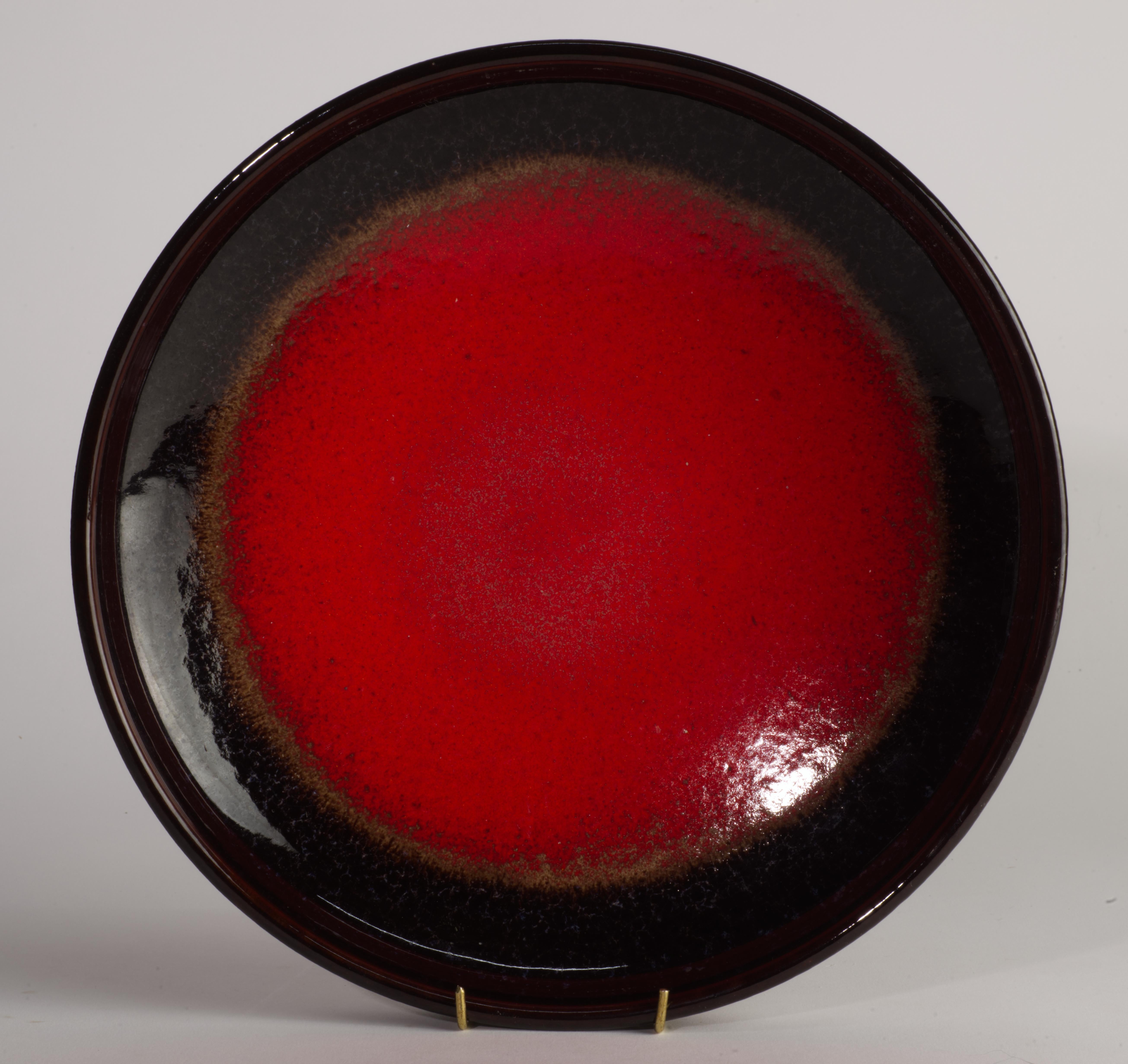  Unusual large bowl in dark red and dark espresso brown glaze was made by Scheurich Keramic in West Germany. 

The bowl is marked on the bottom with the mold number and West Germany, as it was customary for the company. Scheurich always used white