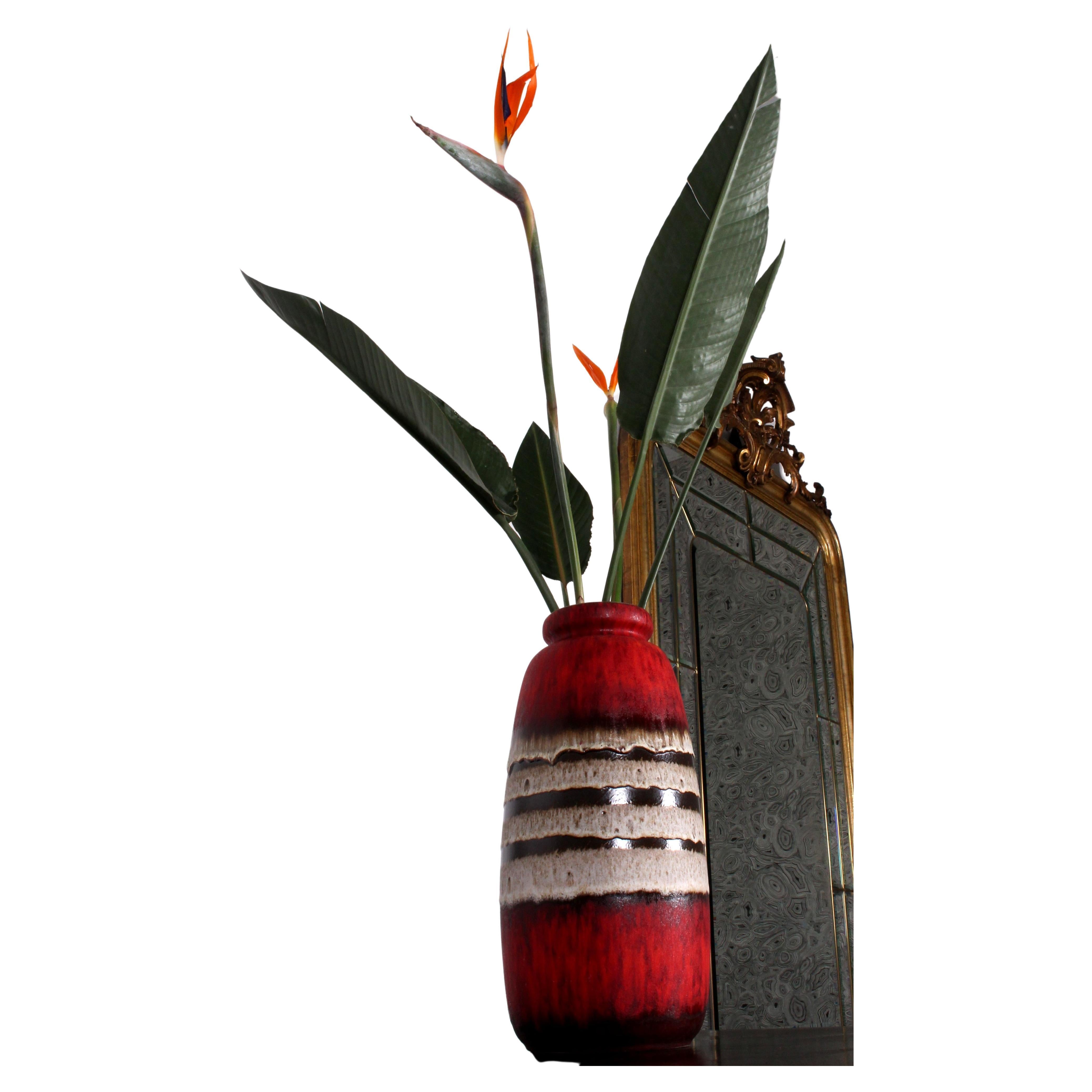 a striking RED FAT LAVA FLOOR VASE no. 284-47
by SCHEURICH

SCHEURICH had its origins in a joint venture launched in 1928 by Alois Scheurich and his cousin Fridolin Greulich in the small town of Schneeberg near the Czech border in Saxony—wholesaling
