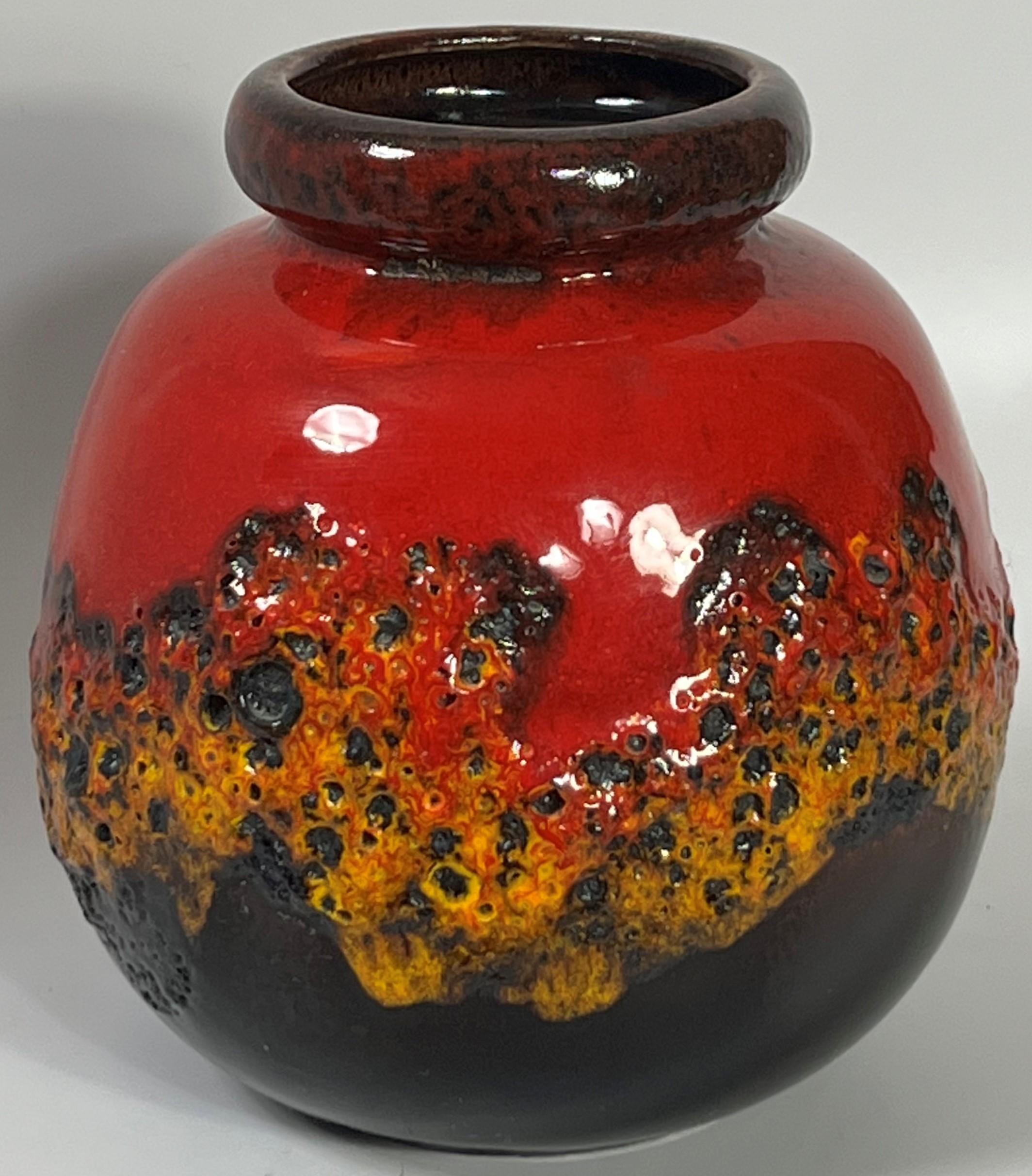 Simply gorgeous volcanic orange red lava dripping and crawling of a dark brown glaze that fired to nearly mirror black coloration. The 284 19 form is proven a perfect vehicle for many of Scheurich's best glazes. Assembling a collection representing
