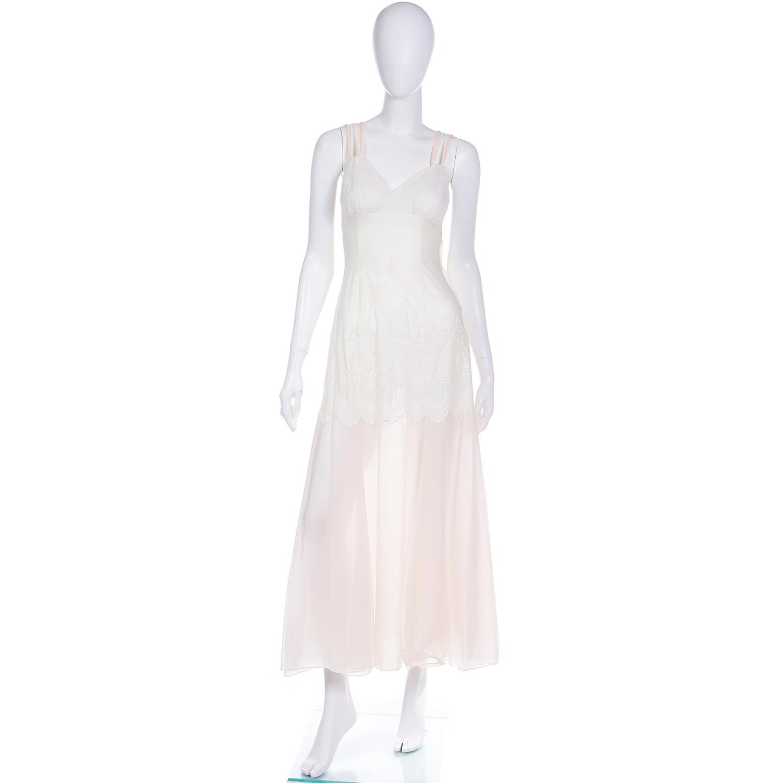 This rare vintage Schiaparelli 2 piece peignoir set is in a light pink and ivory nylon chiffon that takes on an almost ombre effect. This 2 piece set has beautiful details and is from the 1950's.
The long, sheer nightgown has a unique almost mermaid