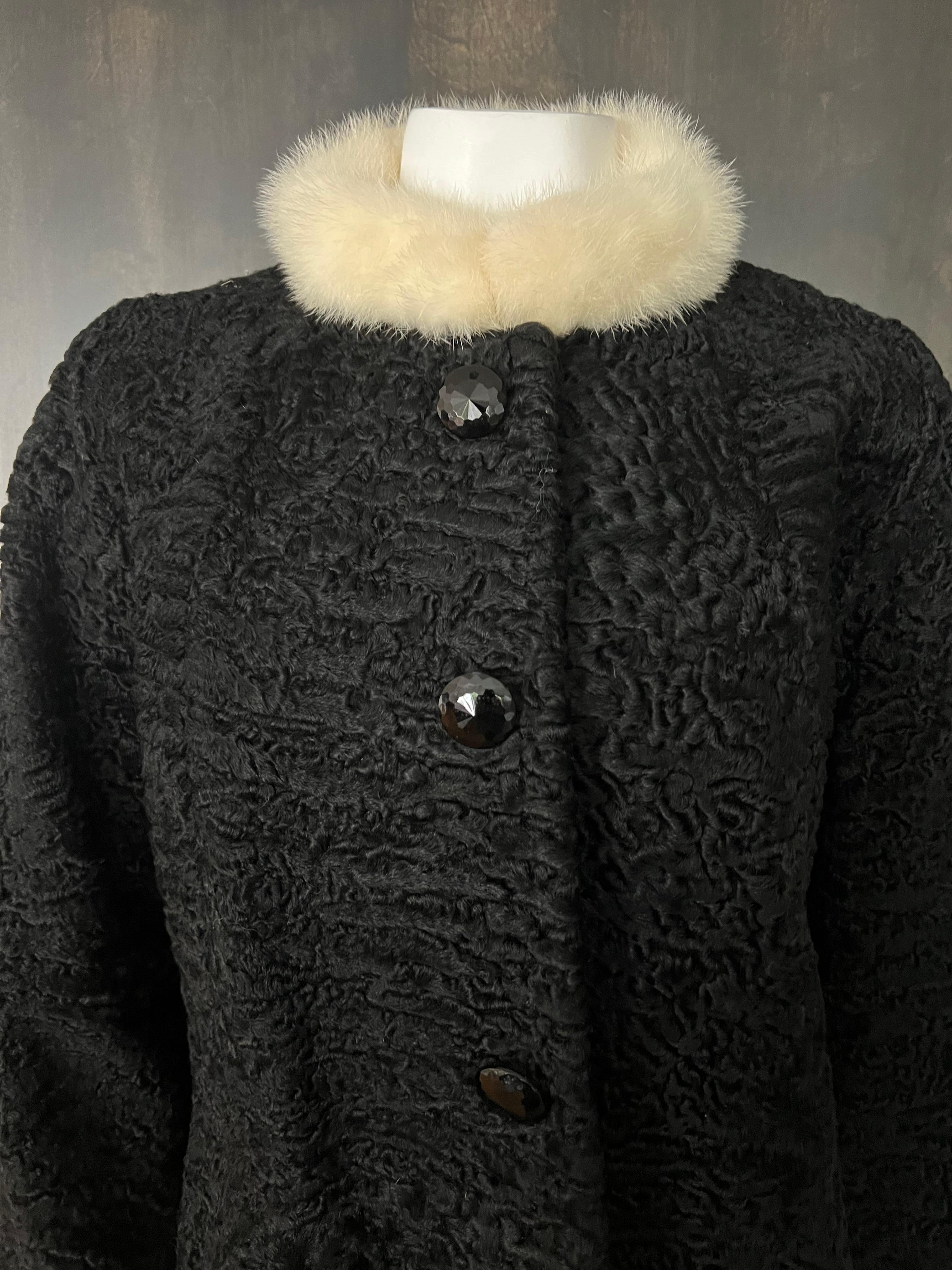 - Black karakul sheep 
- White fur collar
- Three front button closure
- Mid length
