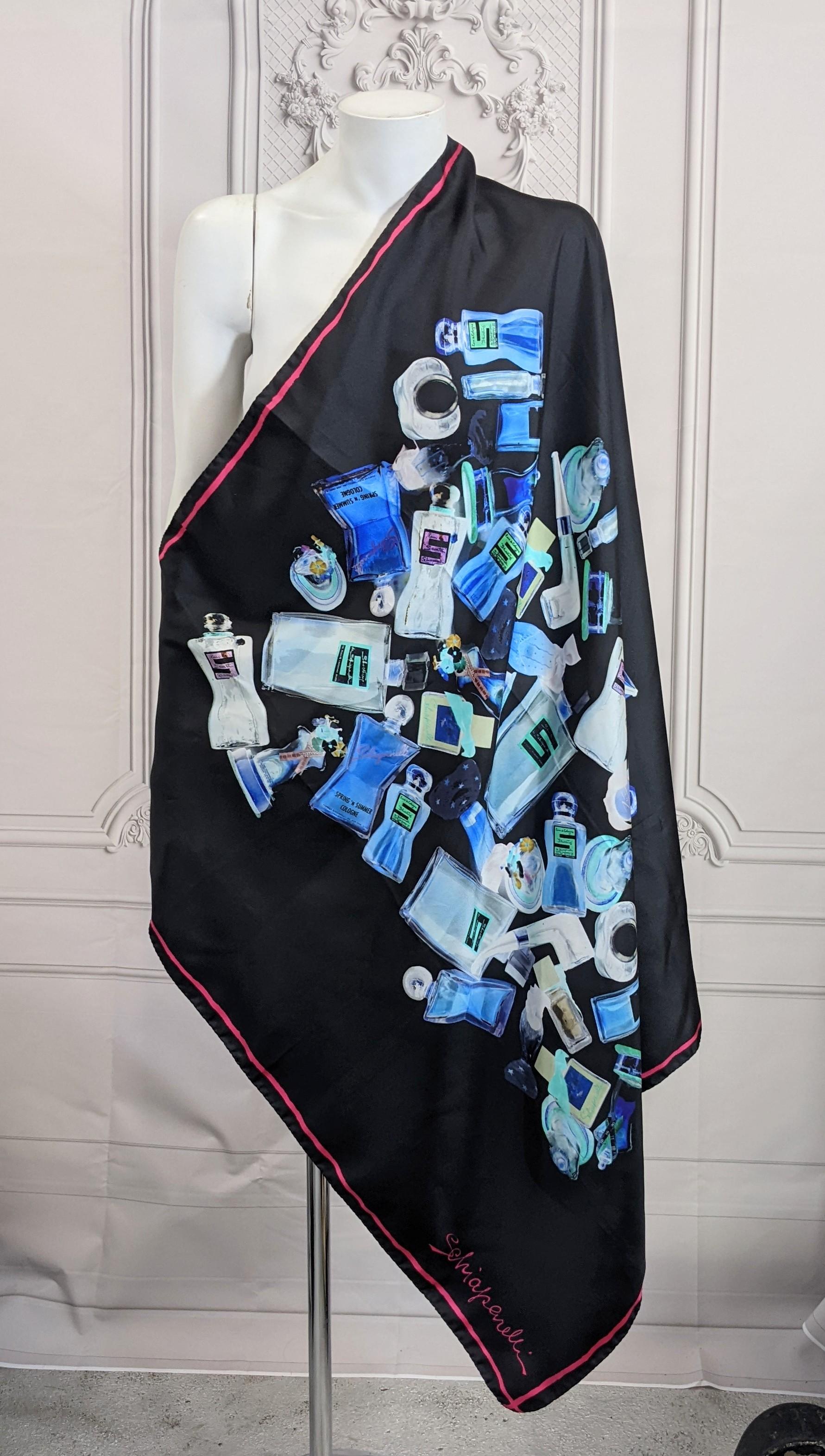 Schiaparelli collector's perfume print scarf. Of silk crepe printed in various shades of blues with a pictoral catalogue of Schiaparelli perfume and the houses perfume and cosmetic products. Including, Arrogantissima, Dance Arrogance, Eau de Santé,