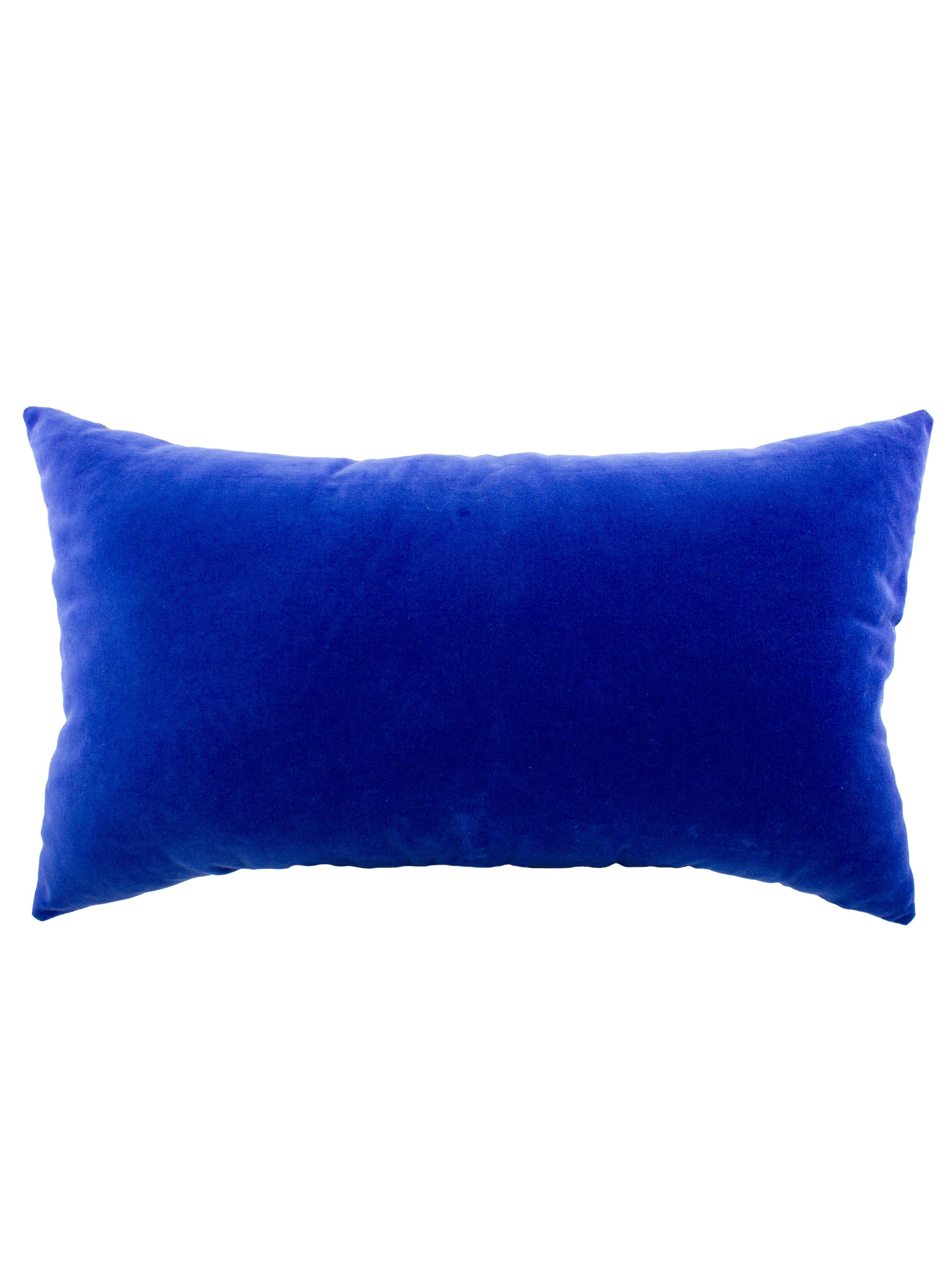 Elevate your living space with this vibrant decorative rectangular cushion made from a repurposed 1970's Schiaparelli silk scarf. The front features a geometric kaleidoscope print in blues, reds and oranges on an off white background. The reverse