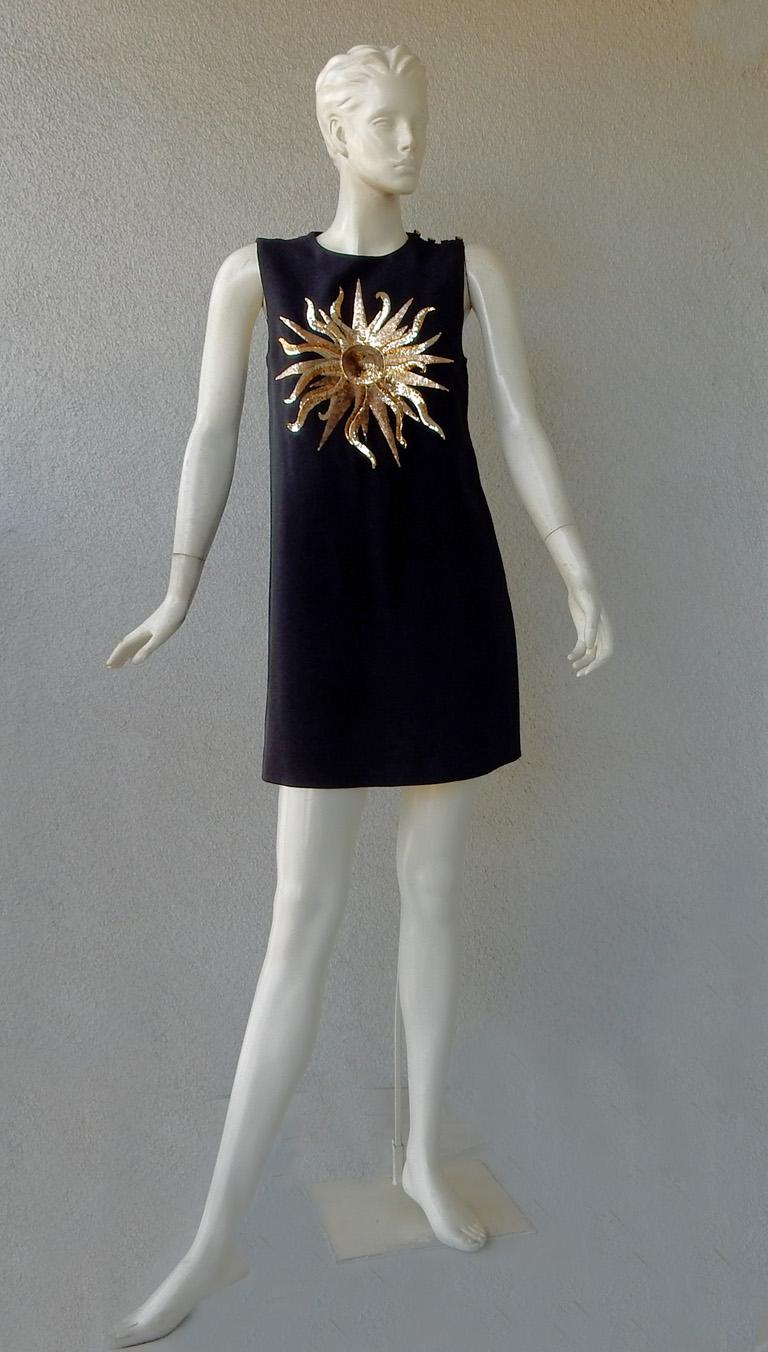 Schiaparelli mini tent dress features round neckline; shoulder closure and side pocket. Shoulder closure fastened with 