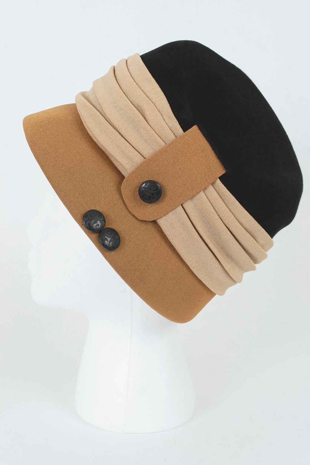 This dramatic cloche combines a modern, neutral colorway with artisanal details like carved buttons and silk jersey pleating to create a hat pairable with anything from a cocktail dress to trousers.

Silk jersey cloche with graduated brim slightly