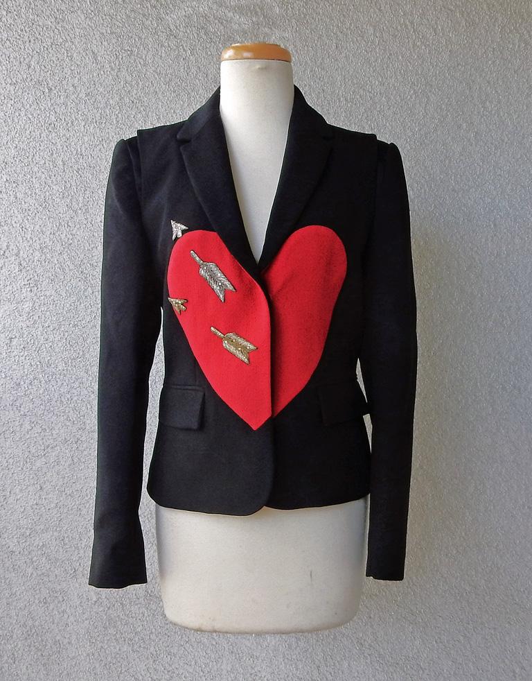 Beautiful Schiaparelli black wool blazer with signature large red heart pierced by embroidered gold arrows, with a small spray of clear stones.  Four (4) small delicate buttons showcasing Signature 