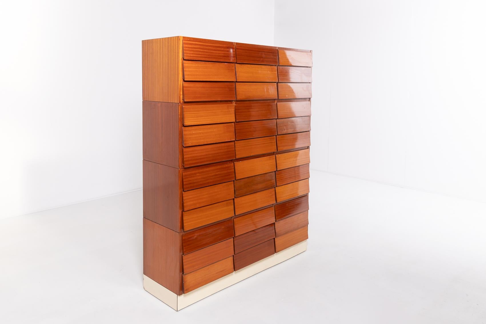 A stunning Italian Mid-Century Modern chest of drawers unit from Schirolli. The unit consists of 4 loose cases with 9 drawers each. Executed in mahogany veneer finish with flap front part.

Condition
Good, usage marks

Dimensions
depth: 40 cm
width: