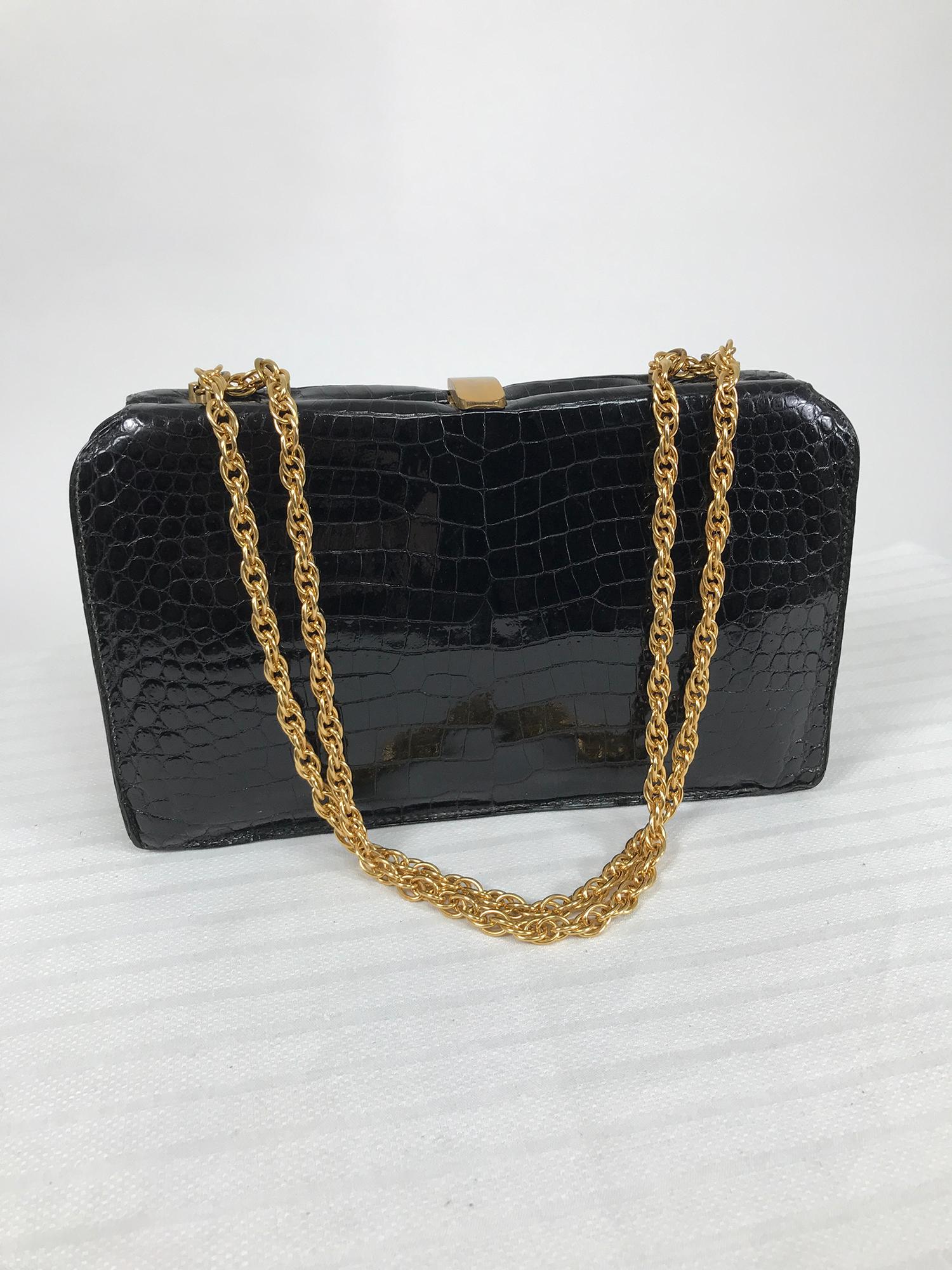 Schitz, Paris rare black crocodile frame handbag with gold hardware from 1953. Schitz was a leather goods shop in Paris retailing luggage, handbags, small cases, umbrellas in exotic leathers.
This beautiful bag is in excellent condition. An interior