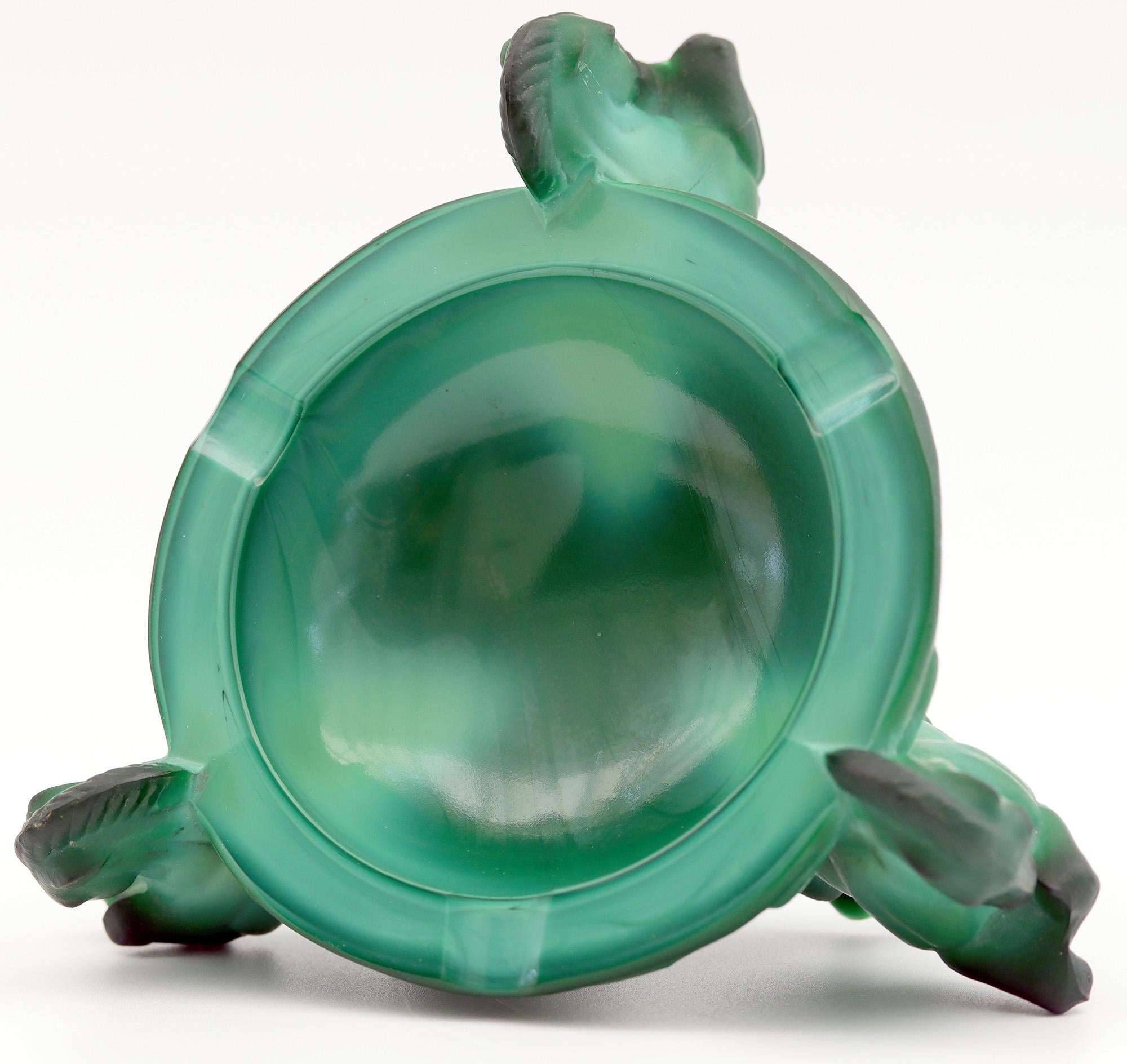 A stylish Art Deco Czech green malachite glass ashtray supported by three rearing ponies attributed to Schlevogt and dating from 1930s-1940s. The rounded ashtray has a recessed polished bowl with three polished cut out cigarette/cigar rests around