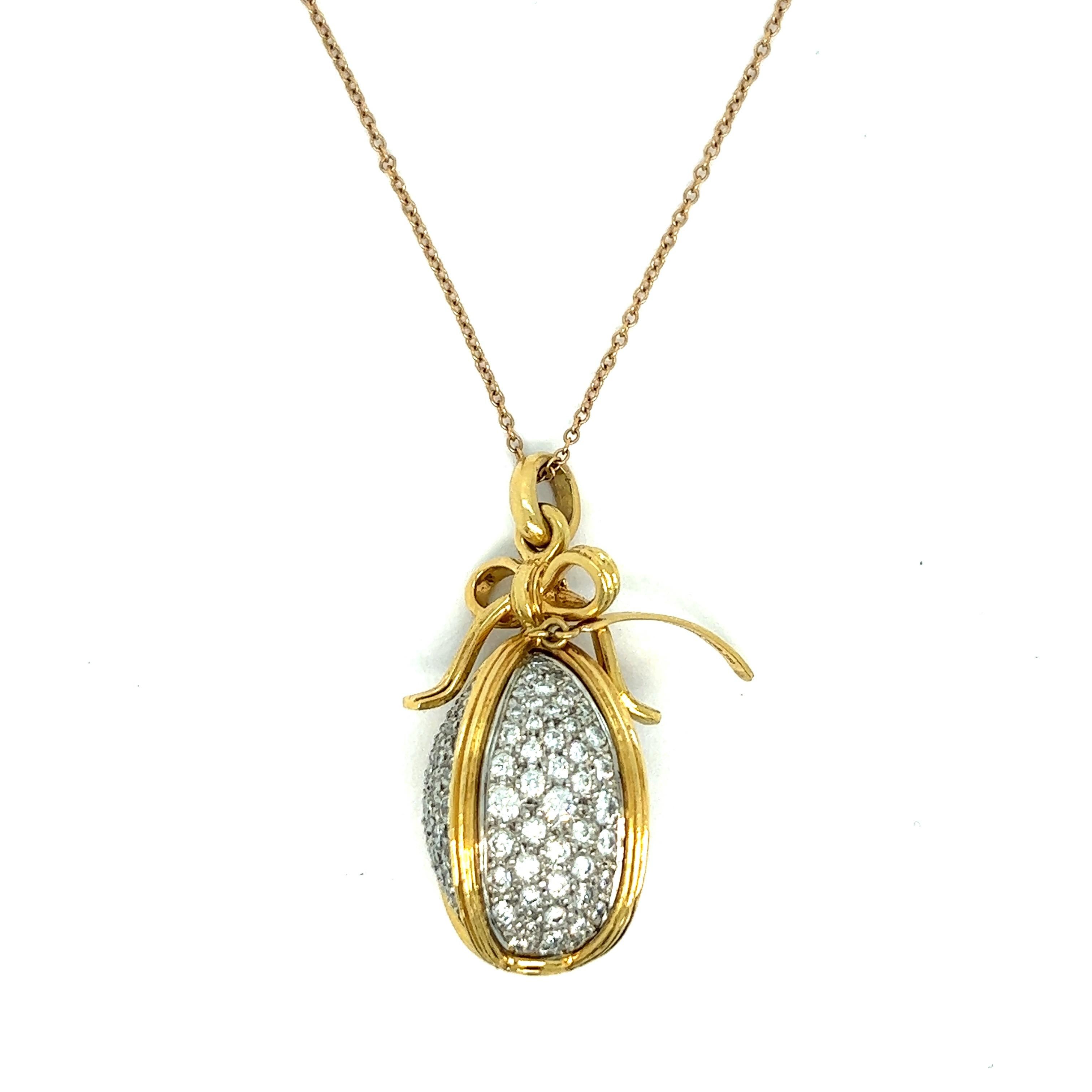 Schlumberger for Tiffany & Co. diamond gold pendant necklace

Round-cut diamonds of approximately 3.5 carats set on 18 karat yellow gold and platinum, ribbon motif; marked Tiffany & Co., Schlumberger Studios, PT950, 750

Size: pendant width 0.5