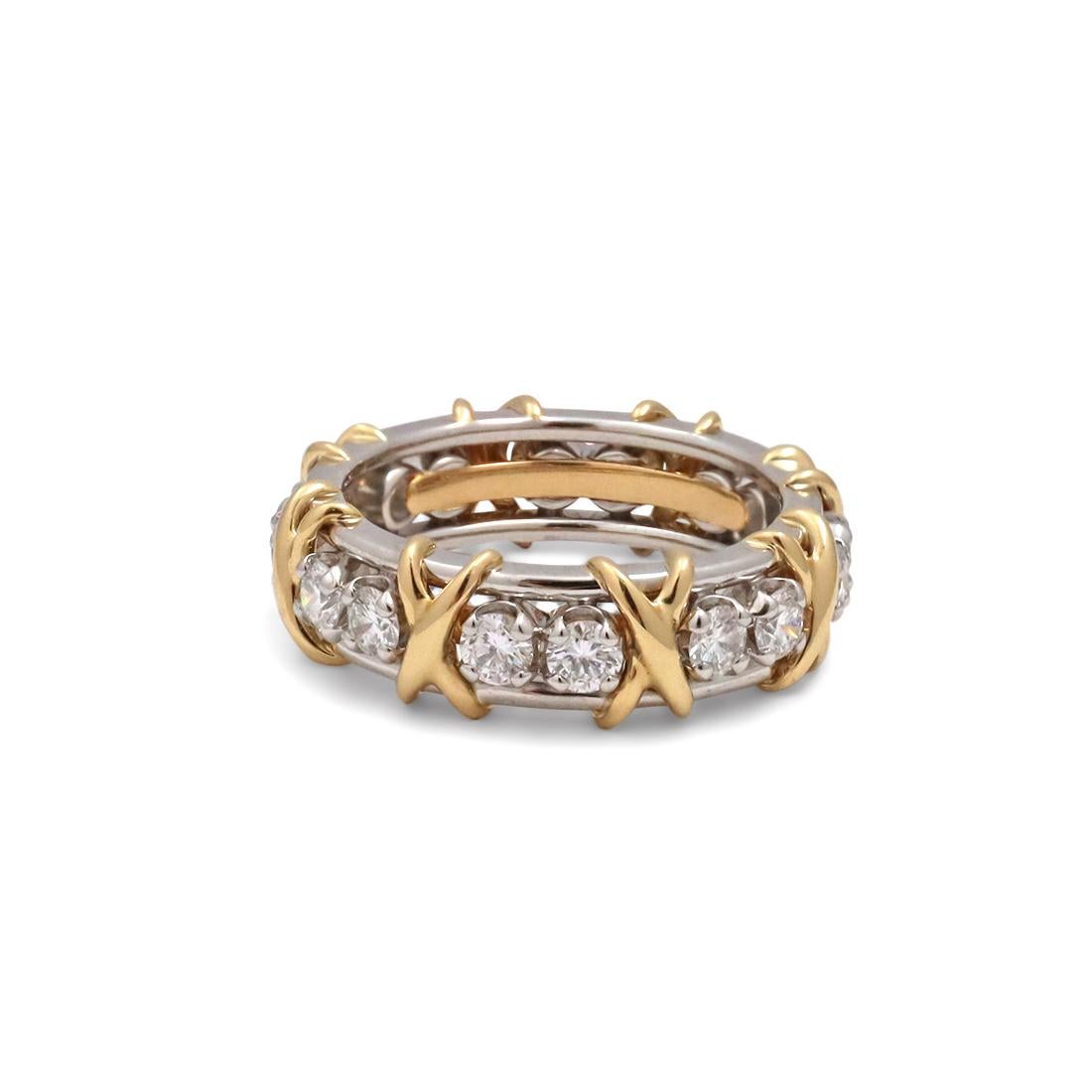 Authentic Schlumberger for Tiffany & Co. ring crafted in platinum comprised of alternating 18 karat yellow gold X's and sixteen sparkling round brilliant cut diamonds weighing an estimated 1.12 carats (G-H, VS). Signed Tiffany & Co. Schlumberger
