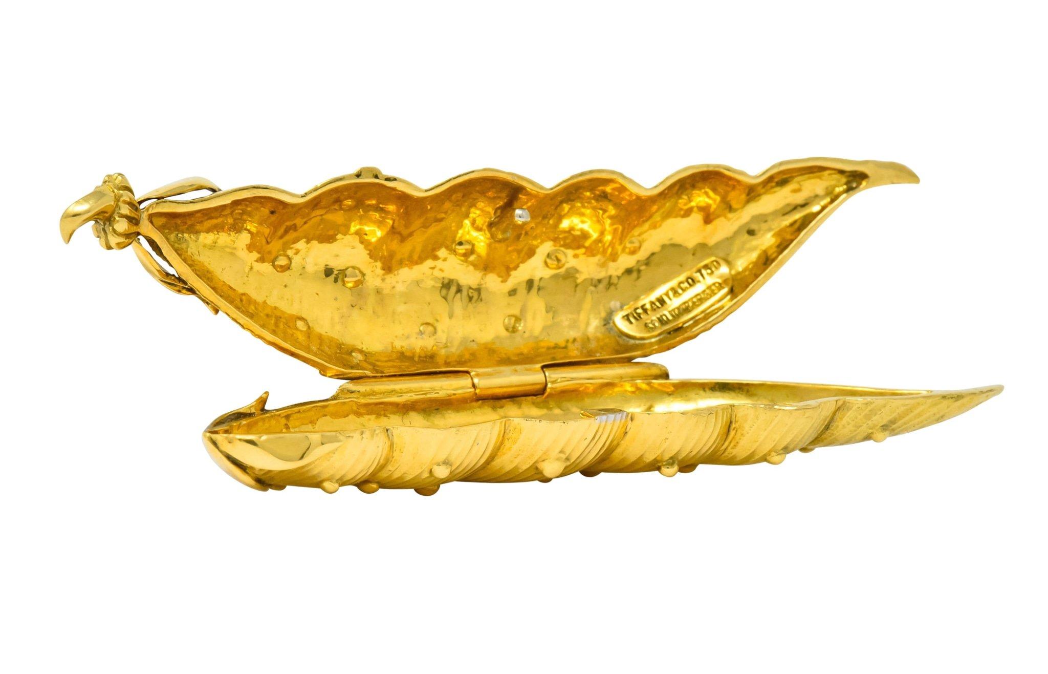 Designed as pea pod shaped repousse pill box with ribbed texture and raised gold bead detail throughout

Topped by decorative foliate stem

Opens on a hinge to reveal a polished gold inside

Signed Schlumberger Tiffany and stamped 750 for 18 karat