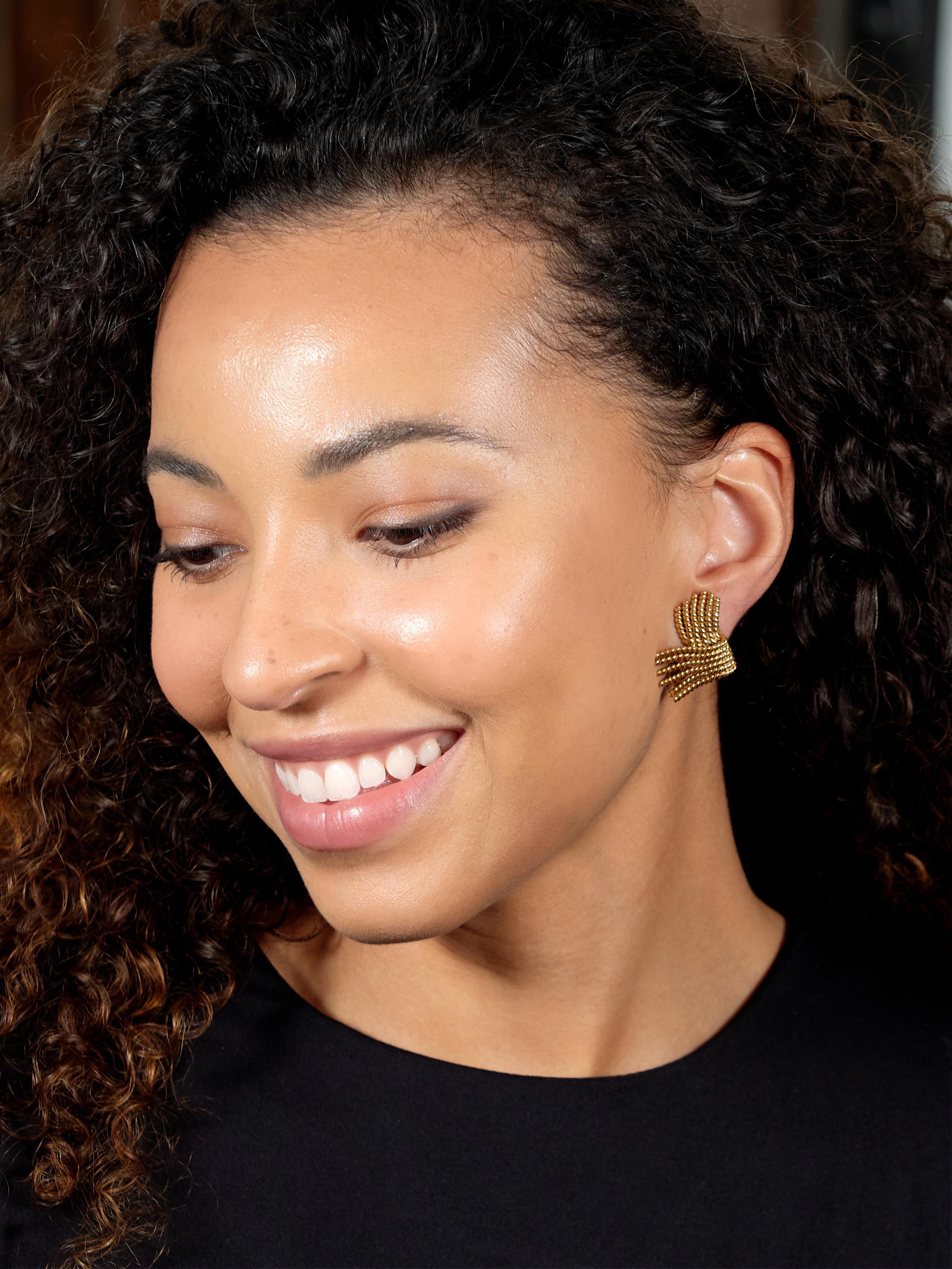 Designed as folded rope strands with fanning terminals
With high polish finish throughout
Completed by hinged omega backs
Stamped for 18 karat gold
Fully signed for Jean Schlumberger for Tiffany 
Co.
Circa: 1960s
Measures: 3/4 x 1 1/4