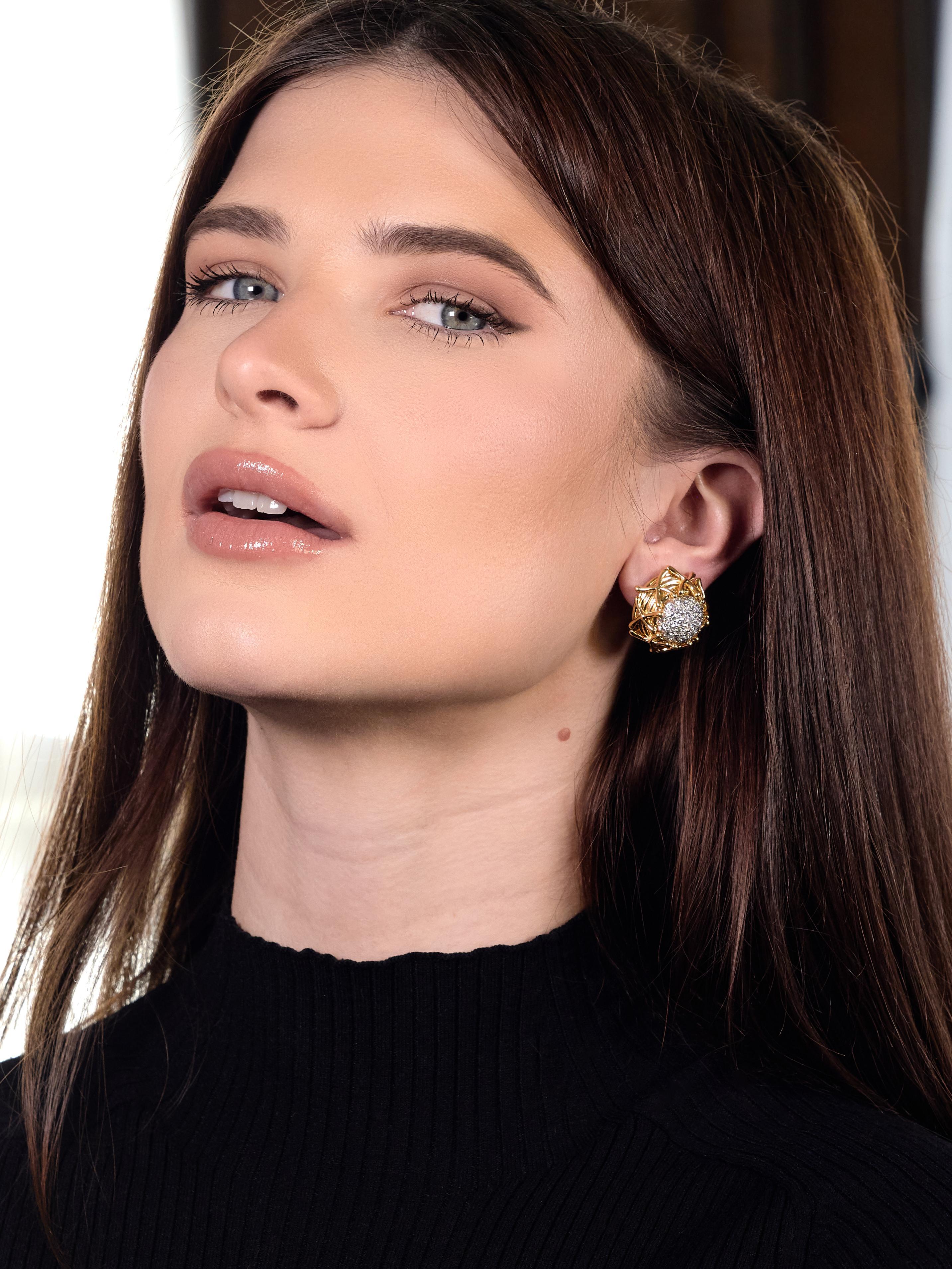Designed as stylized yellow gold nest-like forms with 'X' motif appliqués fully around
Centering domed platinum forms pavé set with round brilliant cut diamonds
Weighing approximately 2.88 carats total - D-G color with VVS-VS2 clarity
With a high