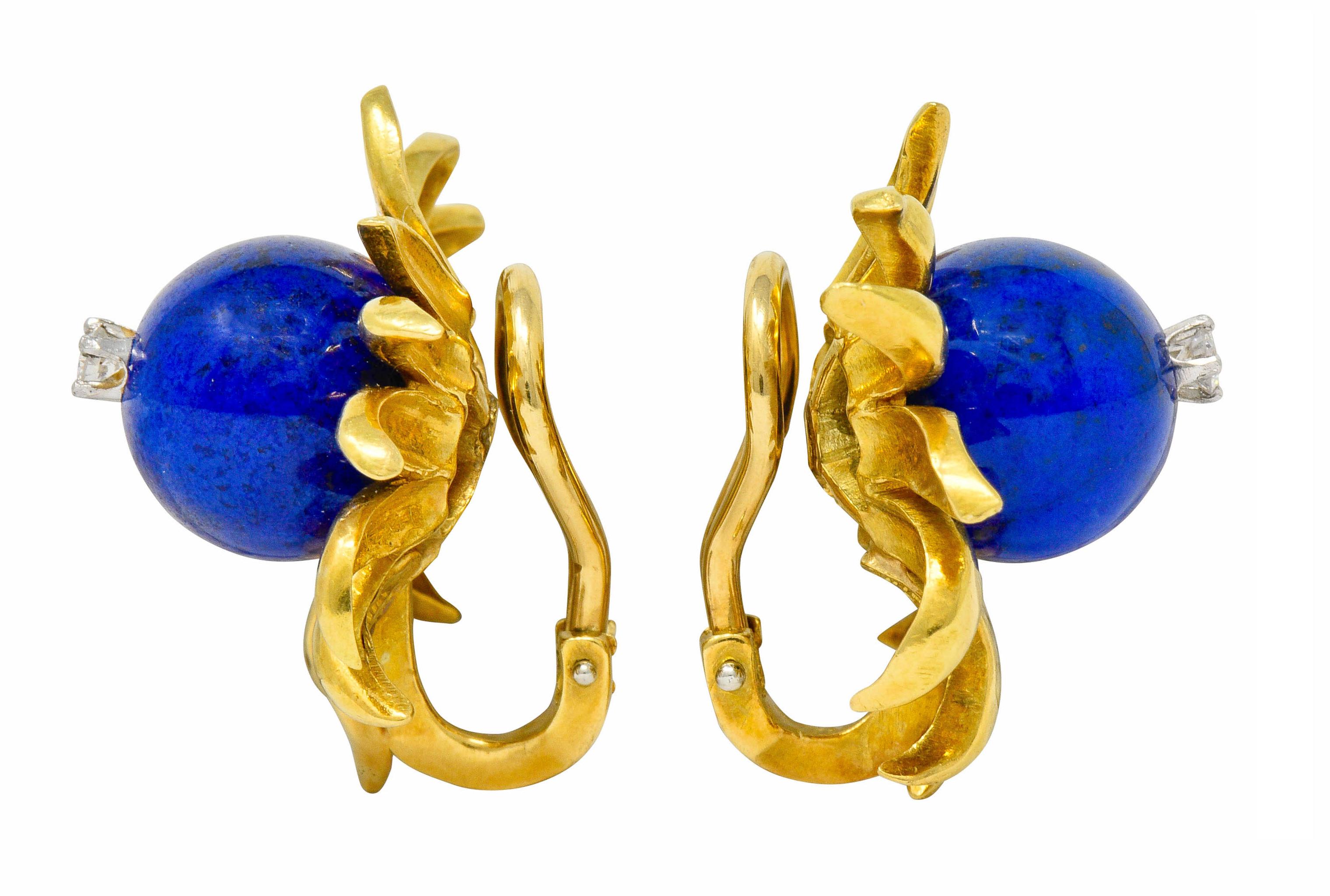 Designed as a stylized flower with wildly dynamic polished gold petals

Featuring an 11.0 mm lapis ball, opaque with incredibly even ultramarine blue color

Centering a round brilliant cut diamond, set in platinum, weighing in total approximately