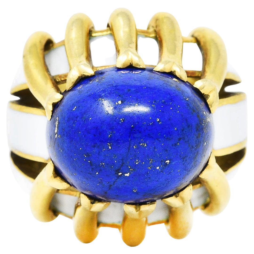 Substantial ring designed as sculptural high polished gold form centering a lapis lazuli cabochon

Lapis is opaque ultramarine blue with moderate mottling and mild pyrite flecking - measures 15.0 x 13.0 mm

Set in place by stylized gold ribbon