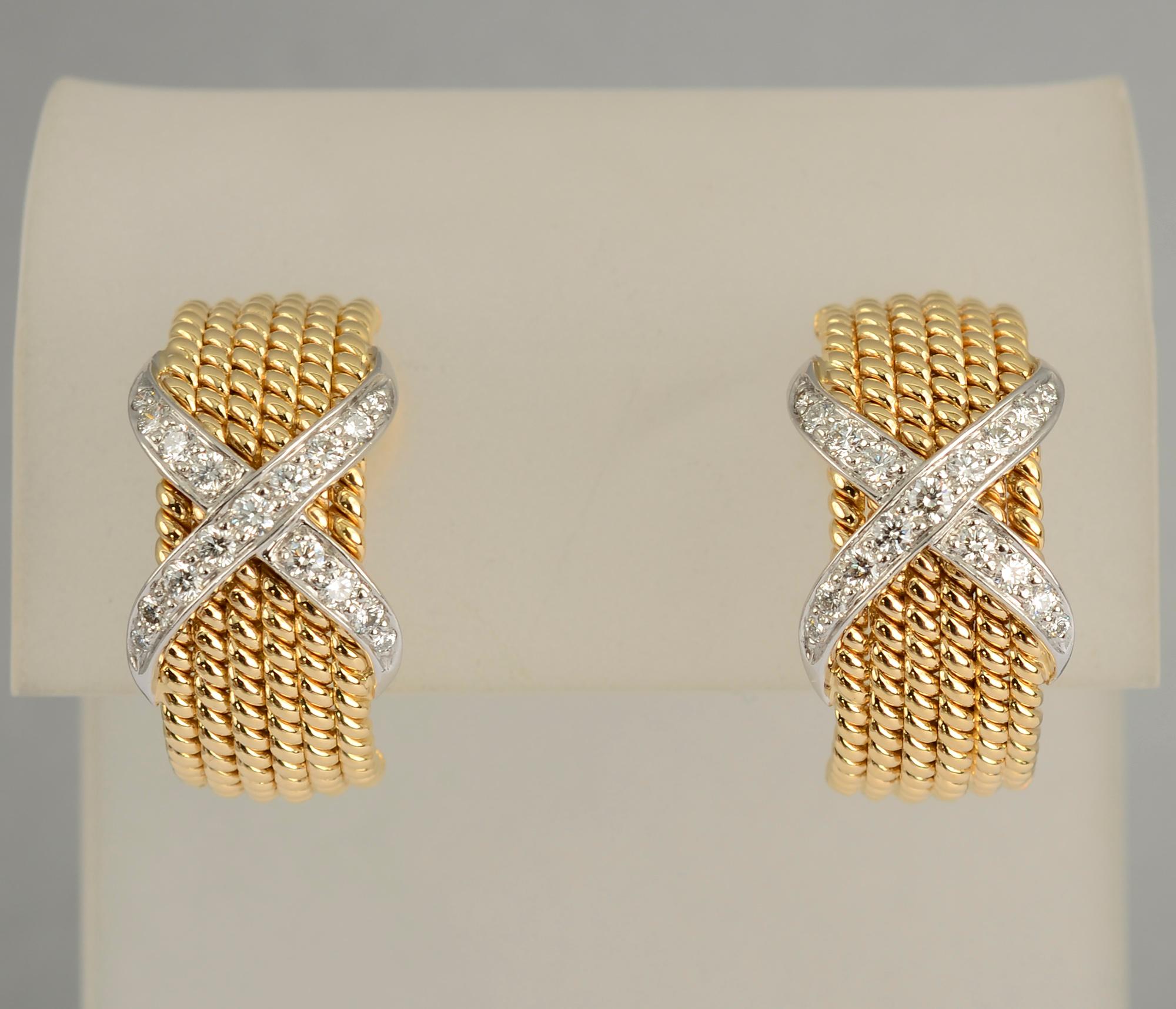 Classic Schlumberger for Tiffany earrings of six rows of twisted gold over which is sumperimposed an X of diamonds. The earrings are 18 karat yellow gold and the diamonds are set in platinum. They measure half an inch wide and three quarters of an
