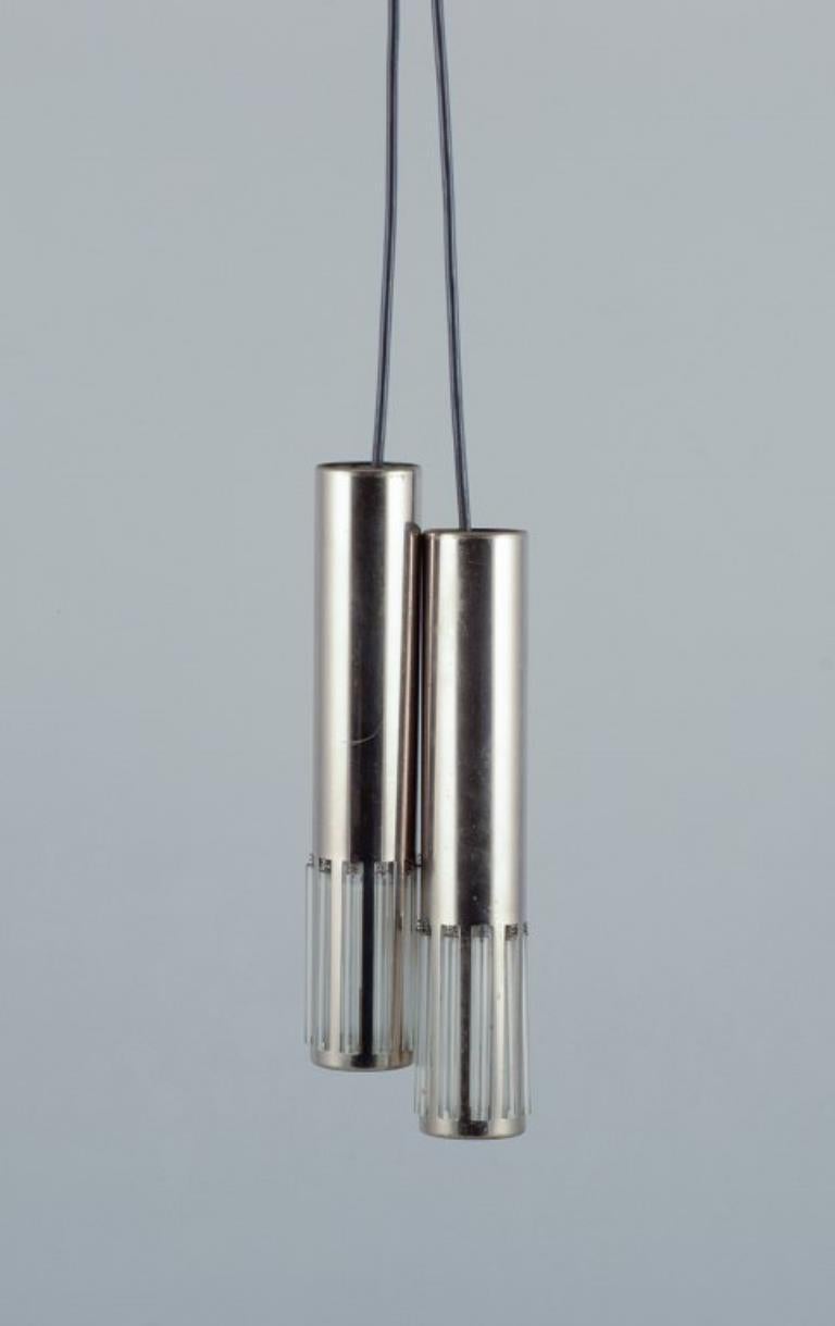 Schmahl & Schulz, Germania. 
Una coppia di pendenti da soffitto in acciaio inossidabile e vetro acrilico.
1970s.
In buone condizioni.
Dimensioni: 28,0 cm x 5,0 cm.