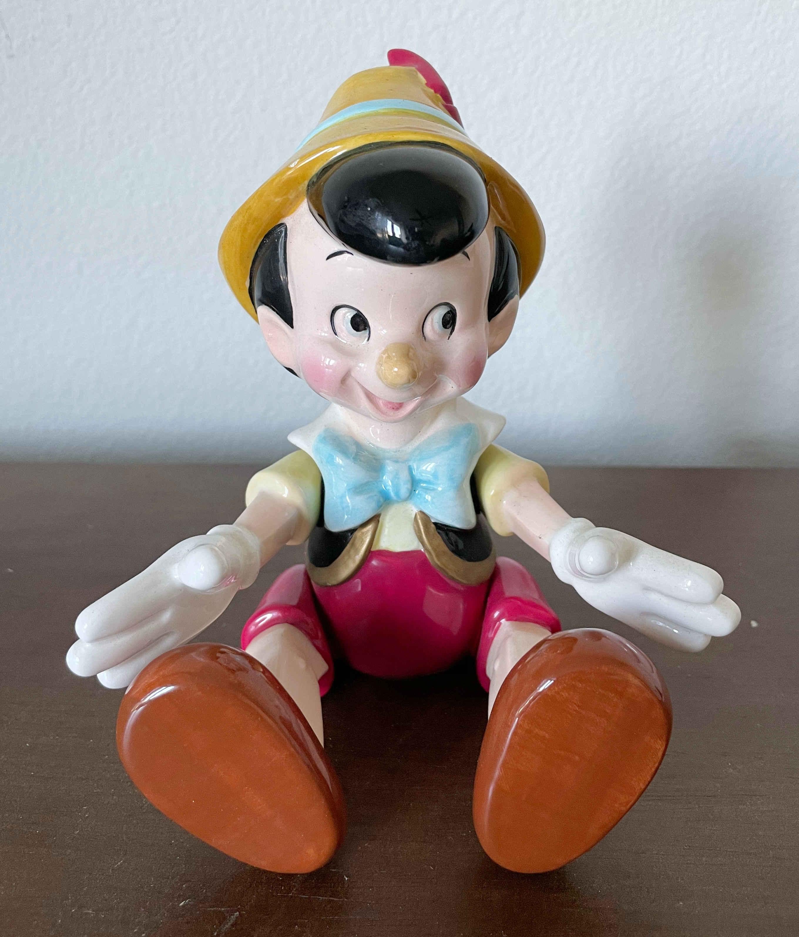 Vintage Schmid Walt Disney gegliederte Pinocchio Spieldose, die The Entertainer spielt / Made in Japan circa 1990s
Abmessungen im Sitzen: Höhe 6 Zoll, Tiefe 4 Zoll, Breite 5,5 Zoll
Abmessungen im Stehen: Höhe 8,5 Zoll, Tiefe 3,5 Zoll, Breite 5,5