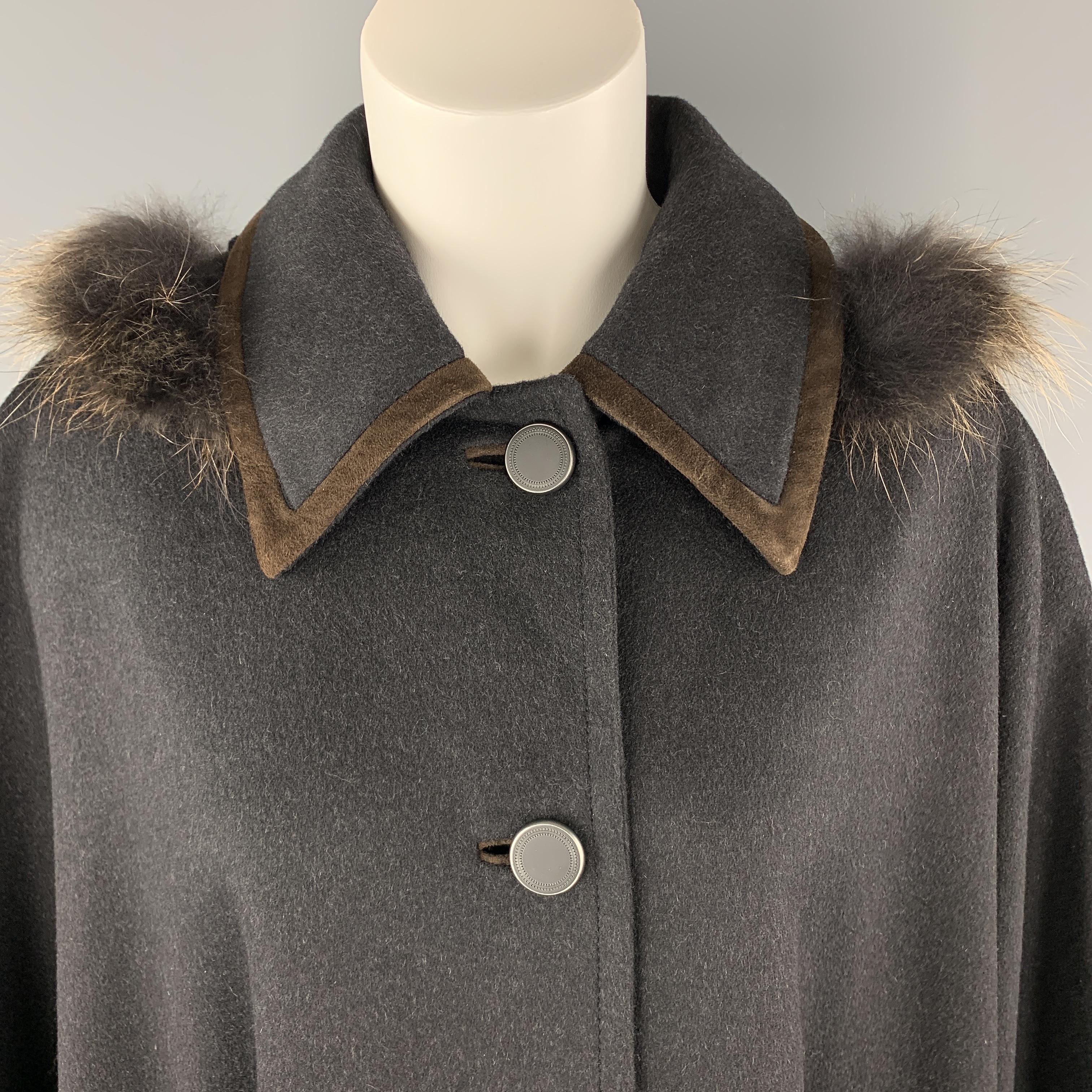 Vintage SCHNEIDERS SALZBURG draped cape coat comes in charcoal wool cashmere blend flannel with a button up front, brown suede trimmed slit pockets, pointed suede trimmed collar, and detachable fur trimmed hood. 

Excellent Pre-Owned